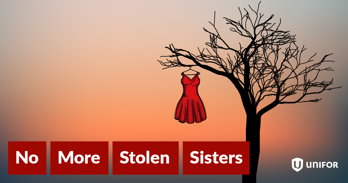 a red dress hanging in a dead tree