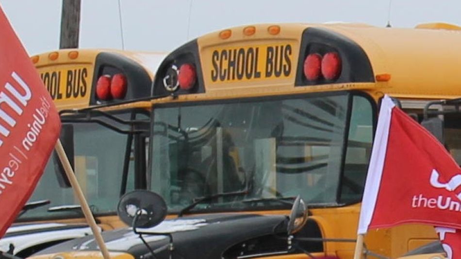 School buses and Unifor flags