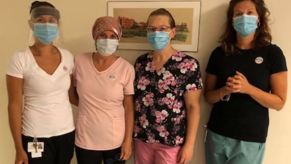 Four health care workers in masks.