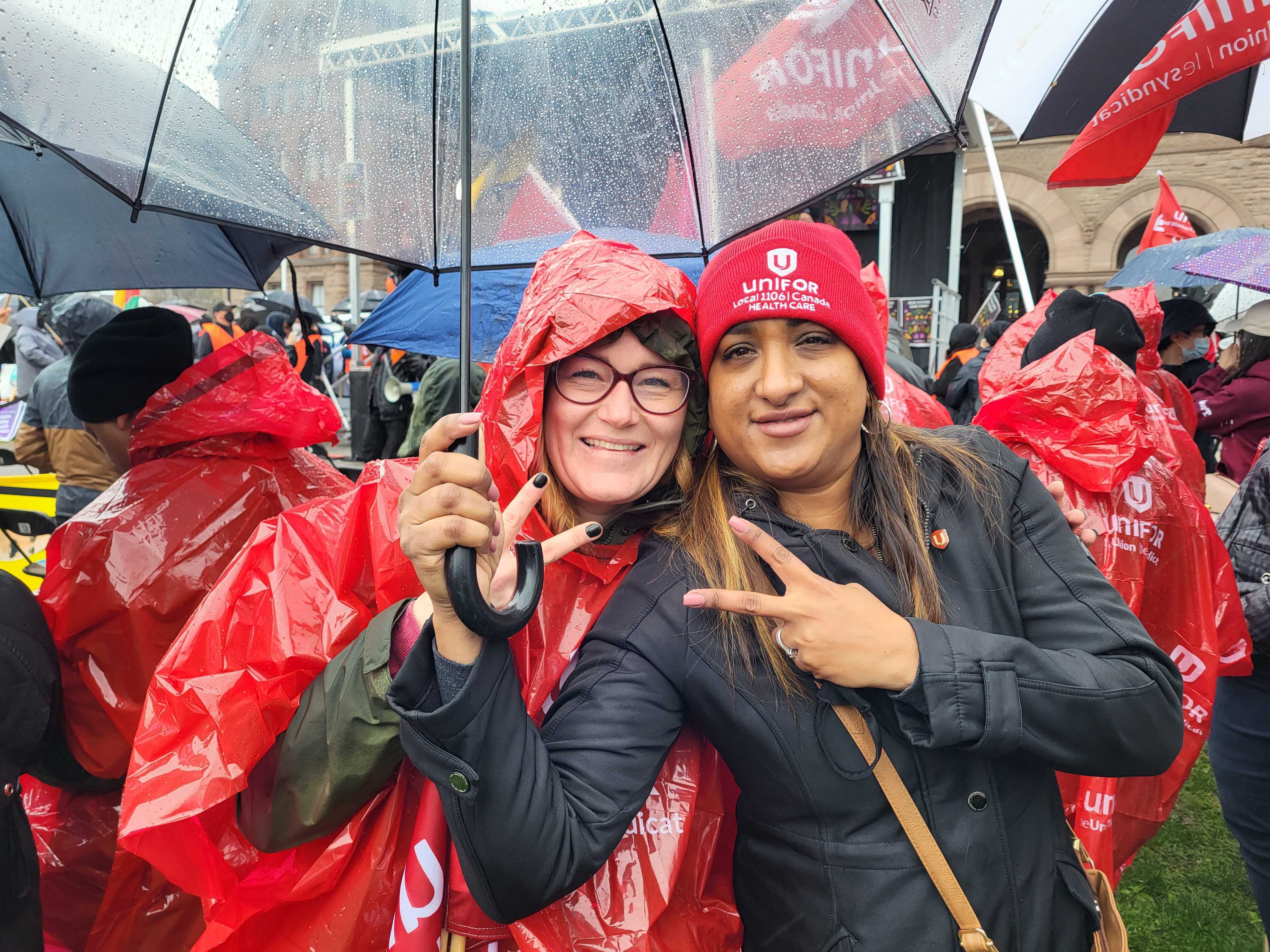 Emily Coulter (right) poses with Unifor member Sarah Kai Antanaitis at the May Day rally in Toronto.