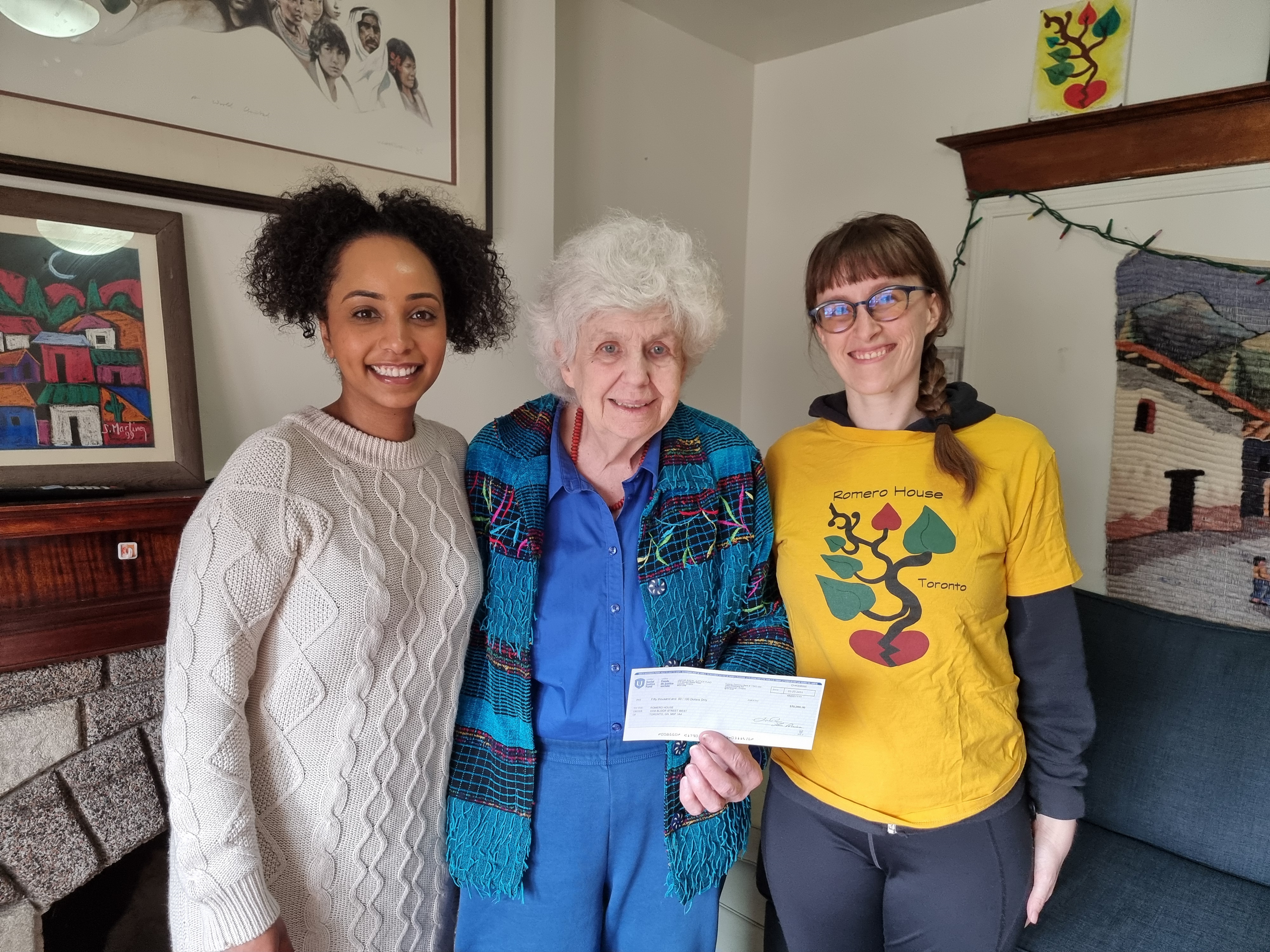Three women holding a cheque