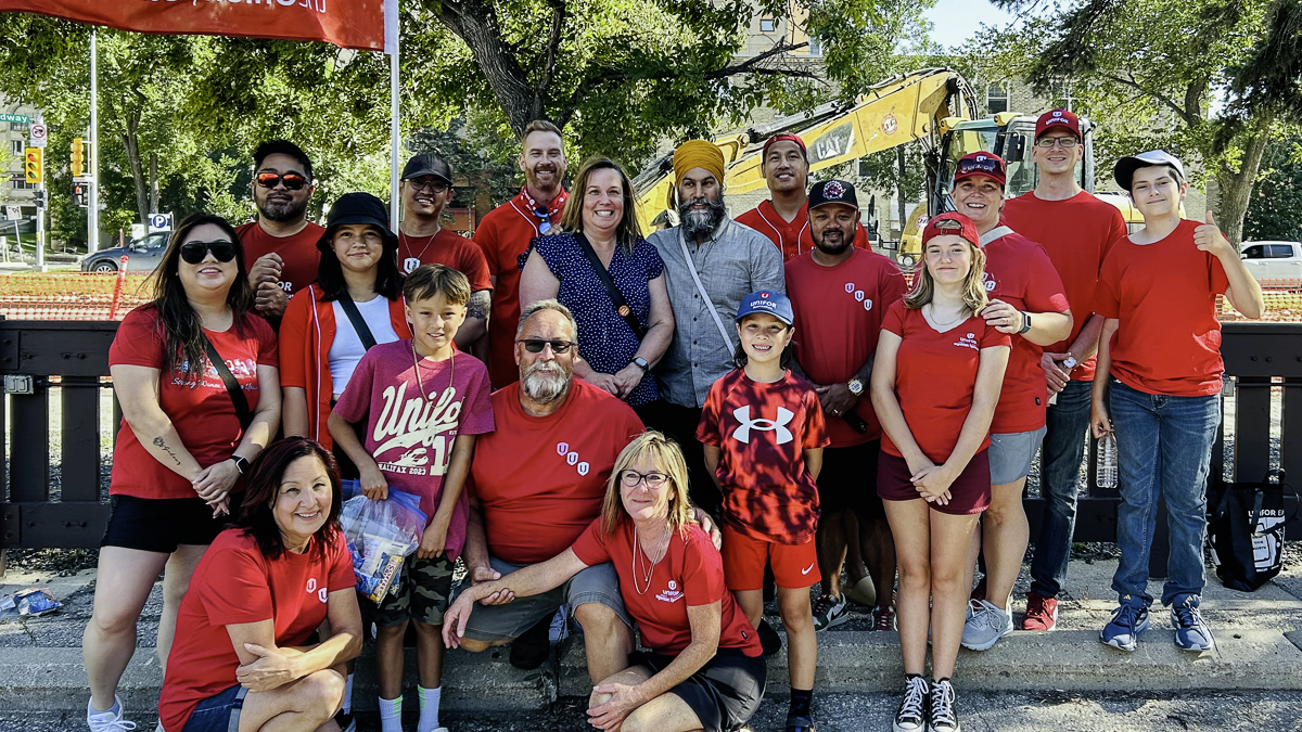 A group of people posing for a picture outside