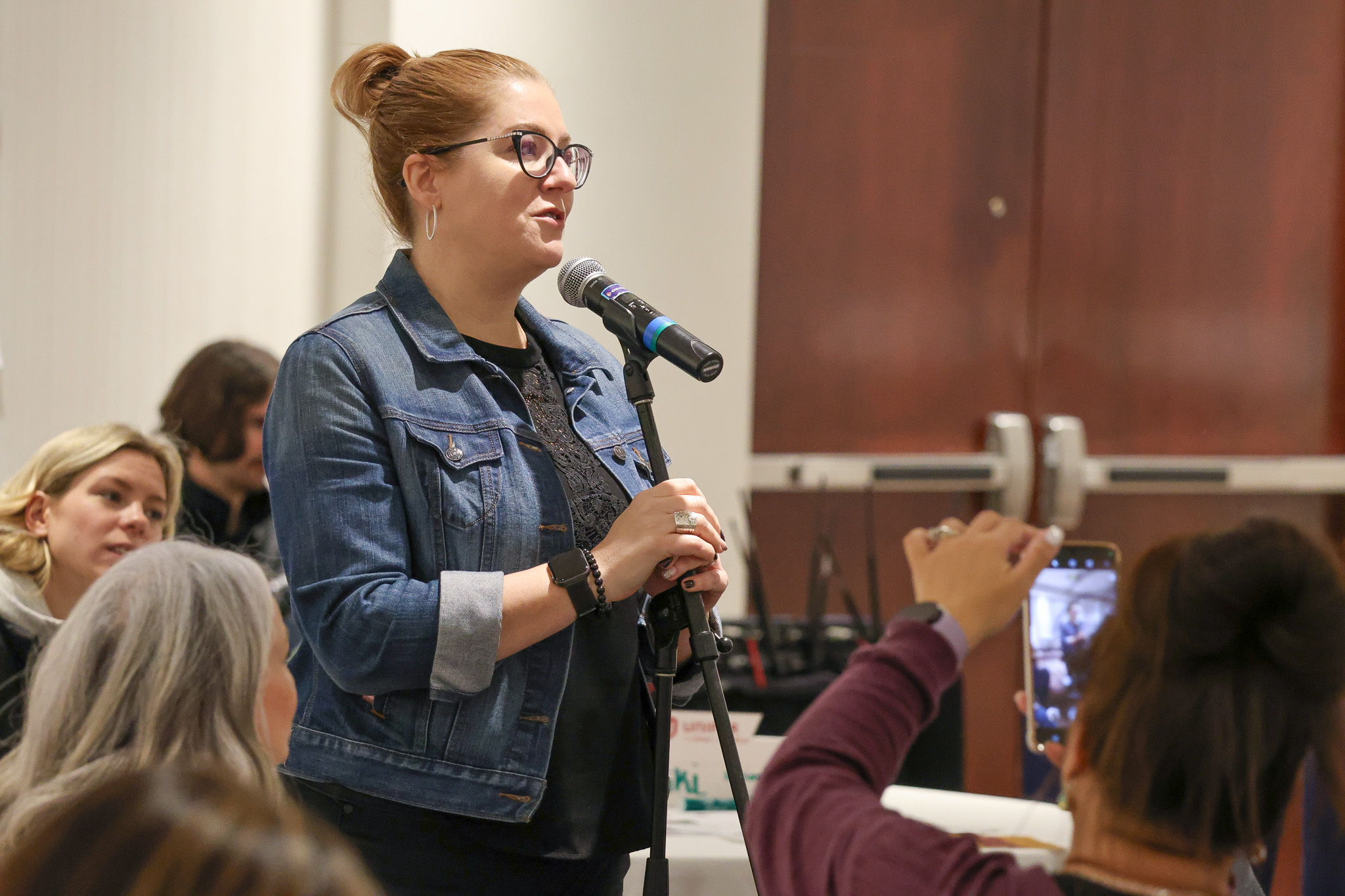 Tracy Ramsey, Unifor Women's Director, standing at a microphone.