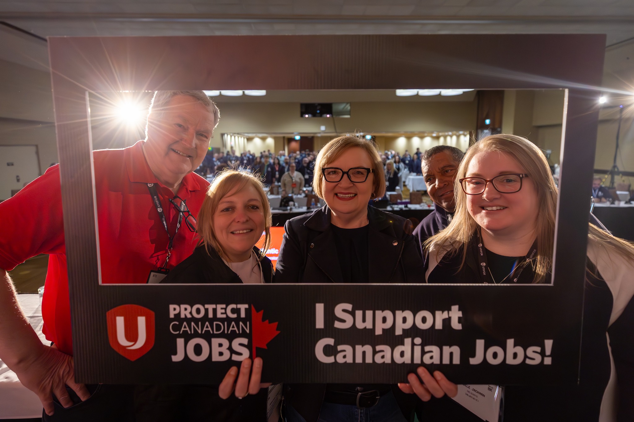 Lana at Podium with Protect Canadian Jobs selfie sign