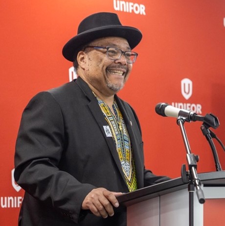 A man speaks at a podium.