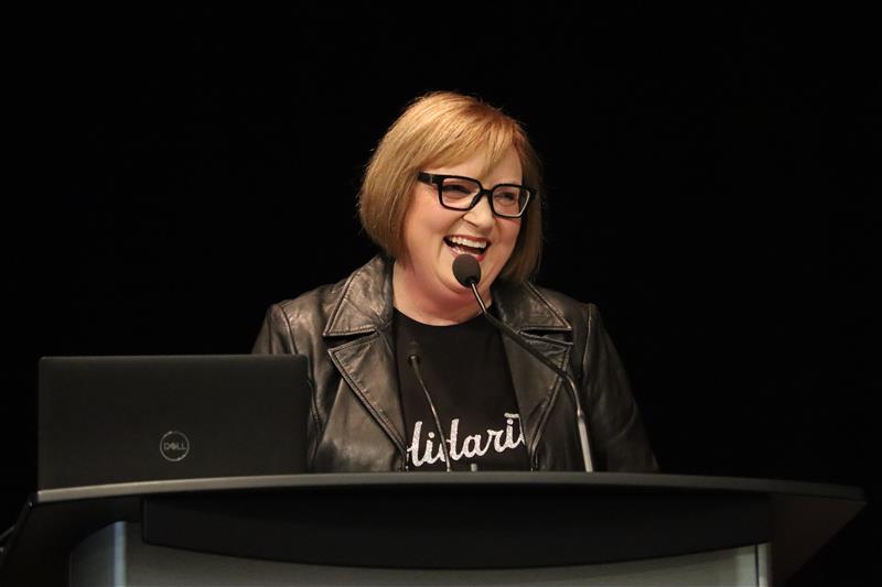 A women speaking at a mic.