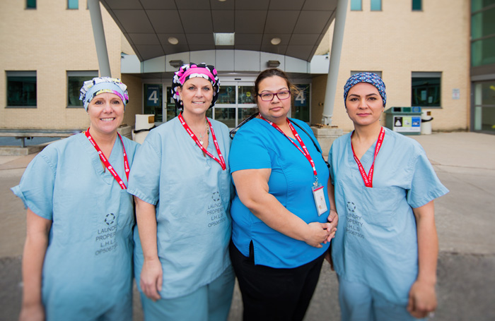 four nurses smiling 