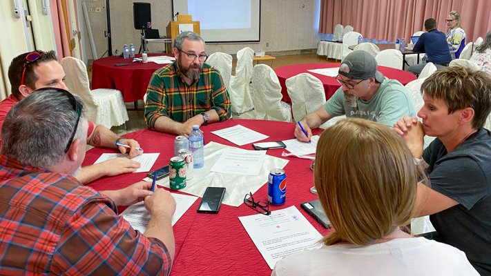 People seated at a round table in a discussion