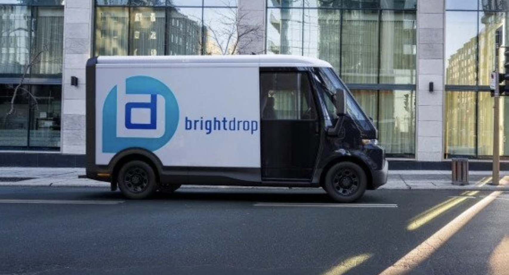 A BrightDrop EV600 electric light commercial vehicle parked on a city street.