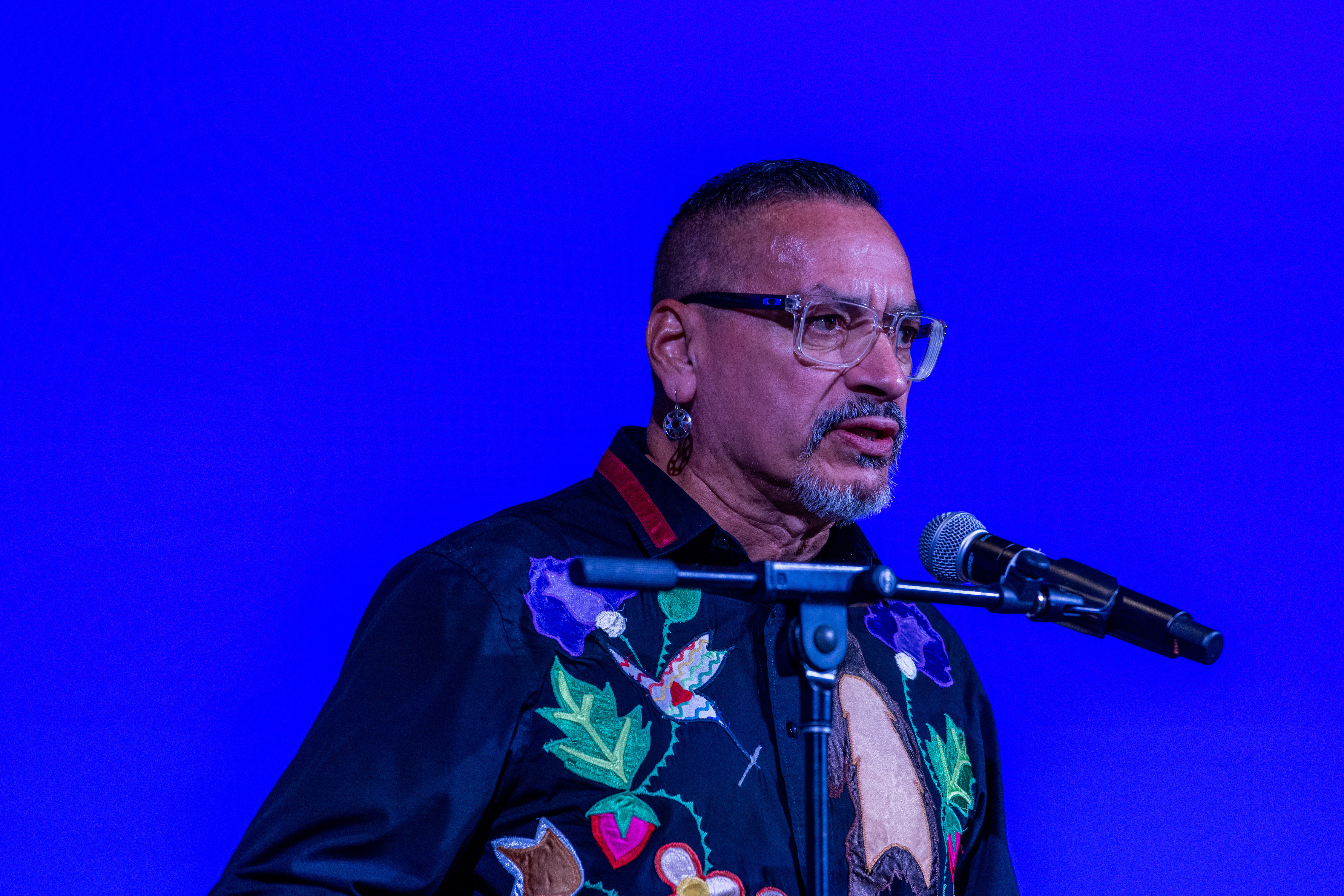 A man speaking at a mic