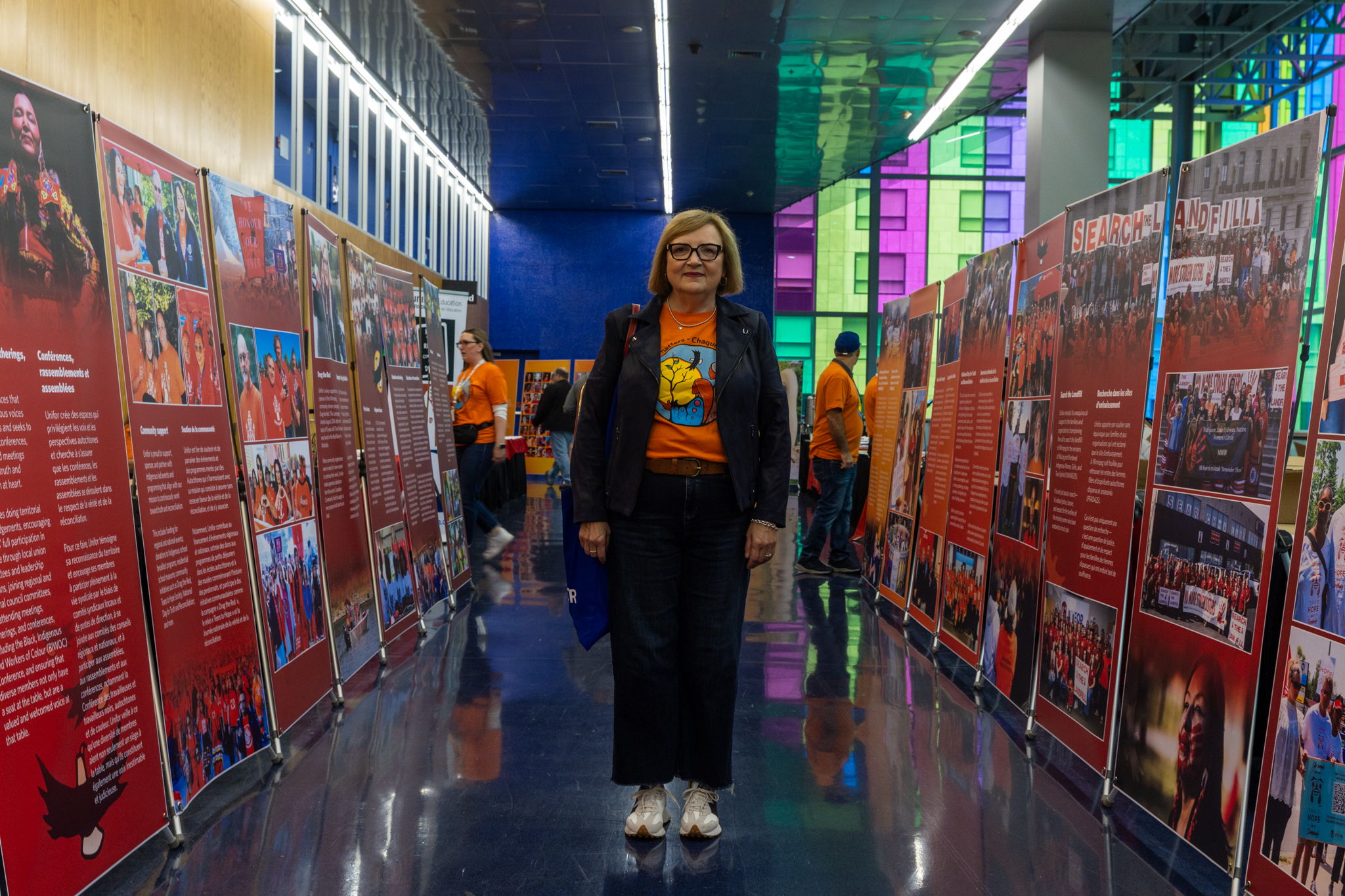 Lana Payne standing in between a row of x-stand banners