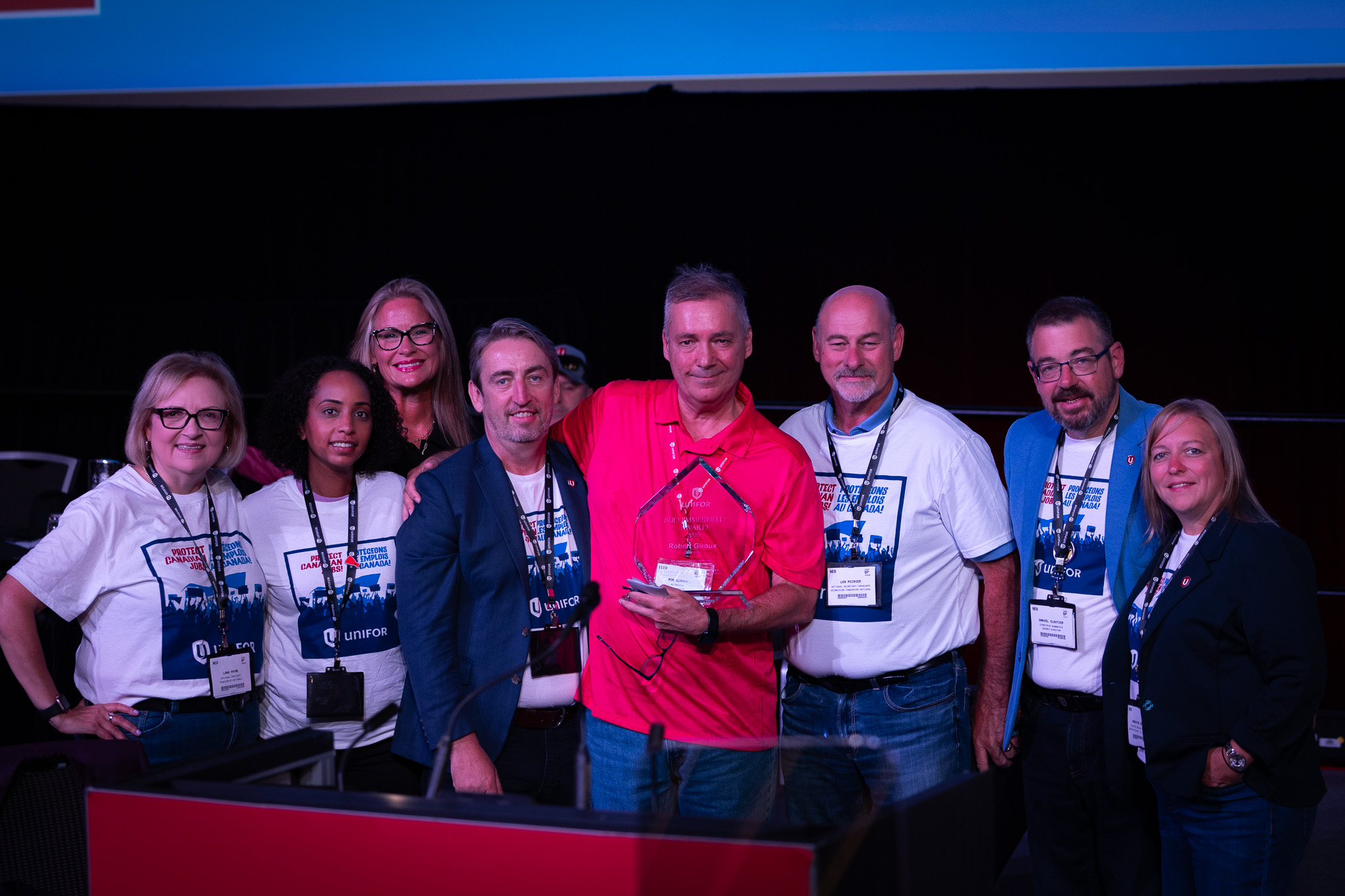 A group on stage arms linked