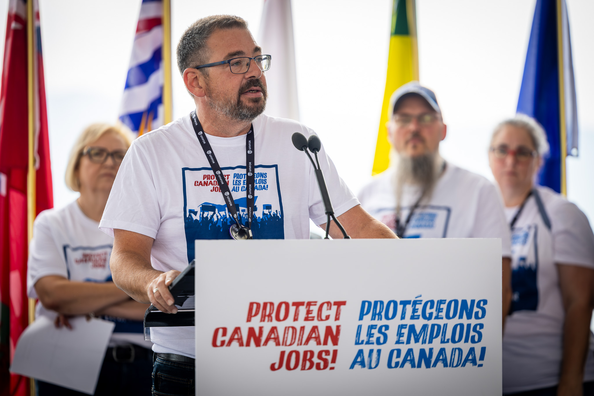 Daniel Cloutier speaking at an outside podium
