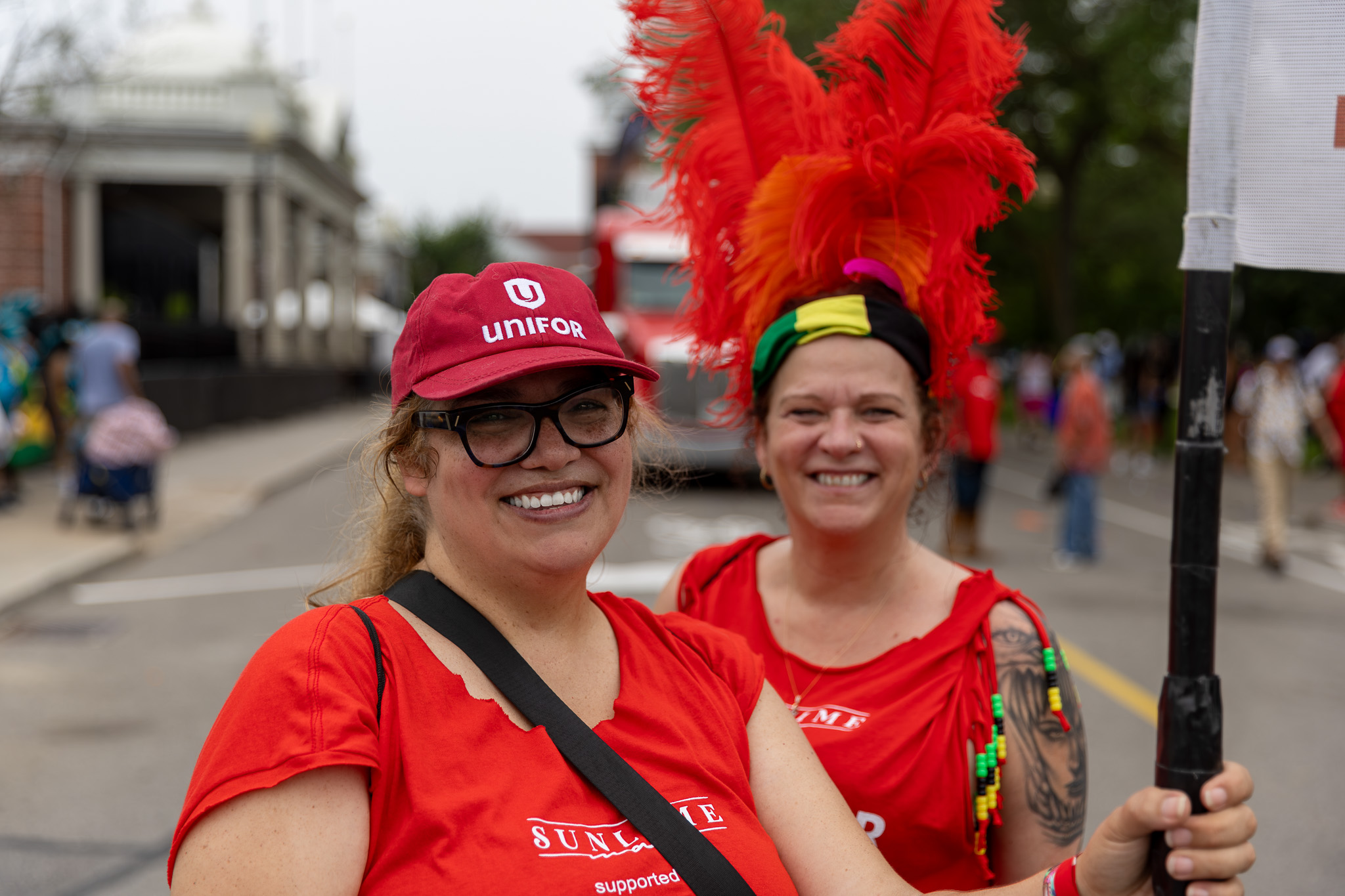 Two women in red shirts smiling