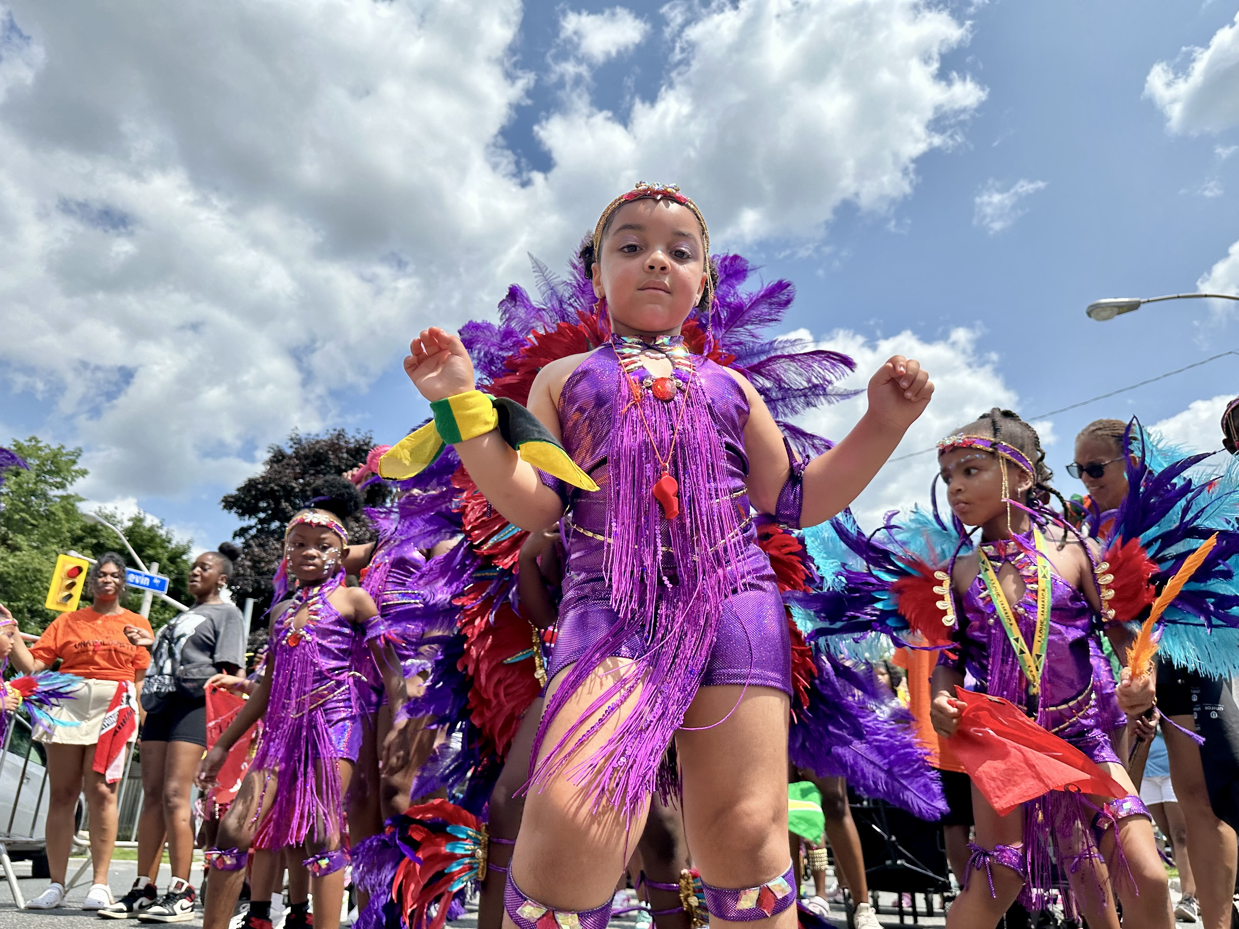 A girl with purple costumes with other kids in the background