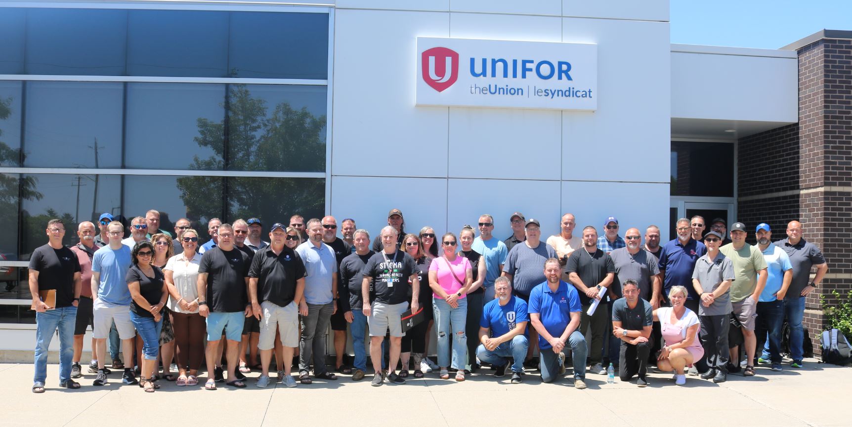 A large group outside a Unifor building