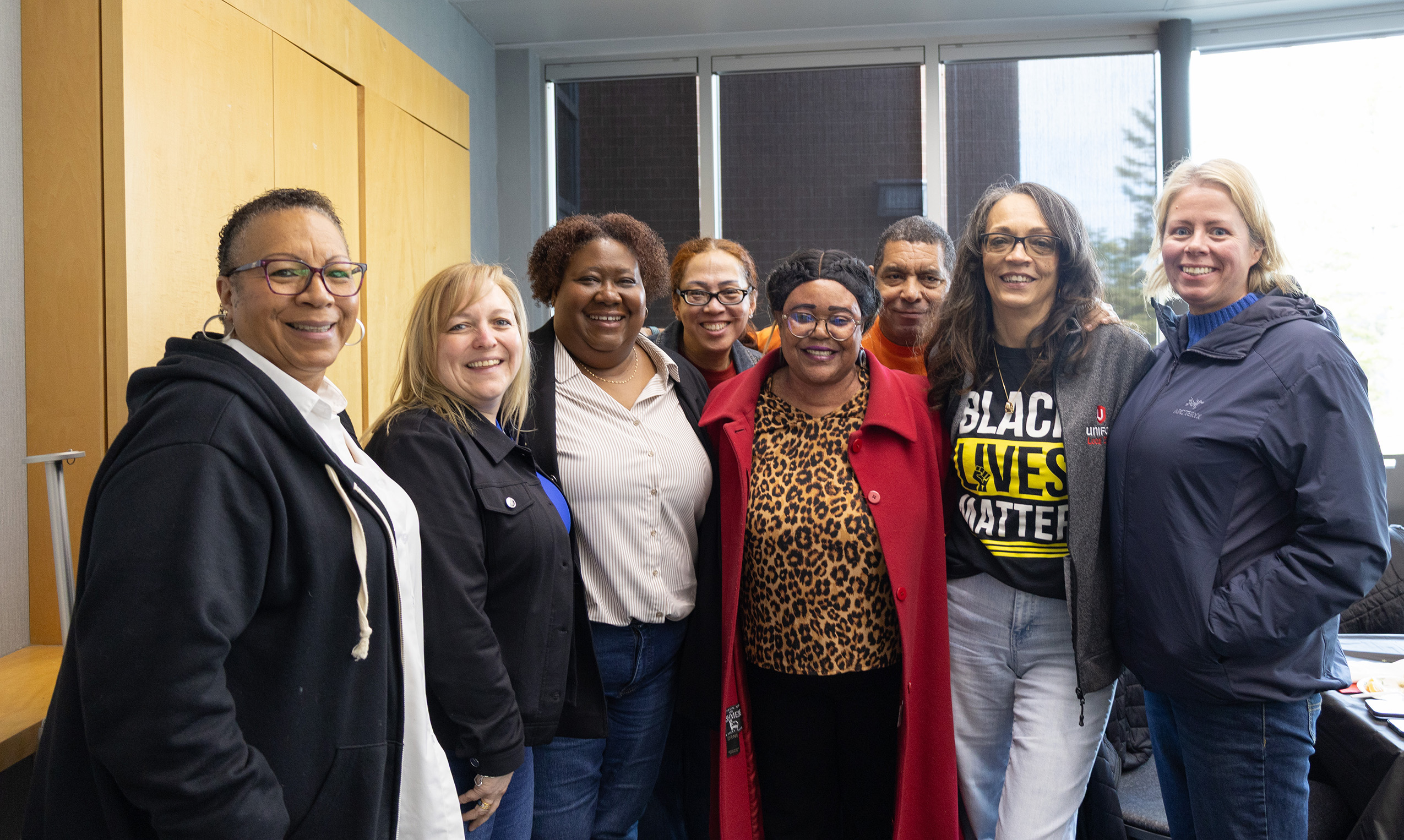Eight people smiling at the camera