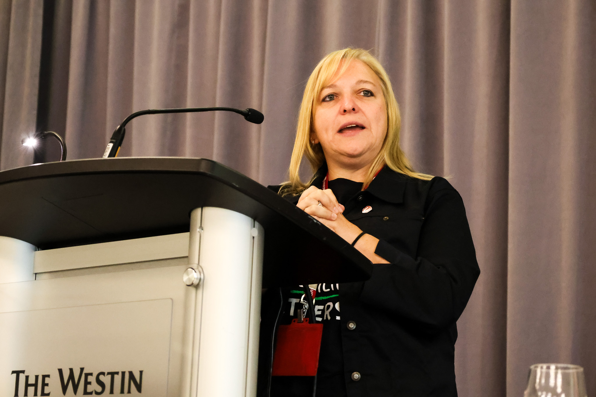 A women speaks at a podium