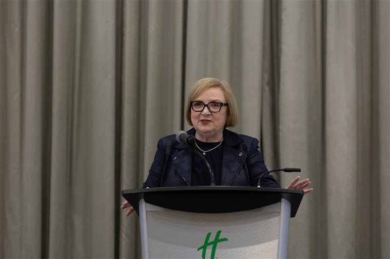 A women speaks at a podium