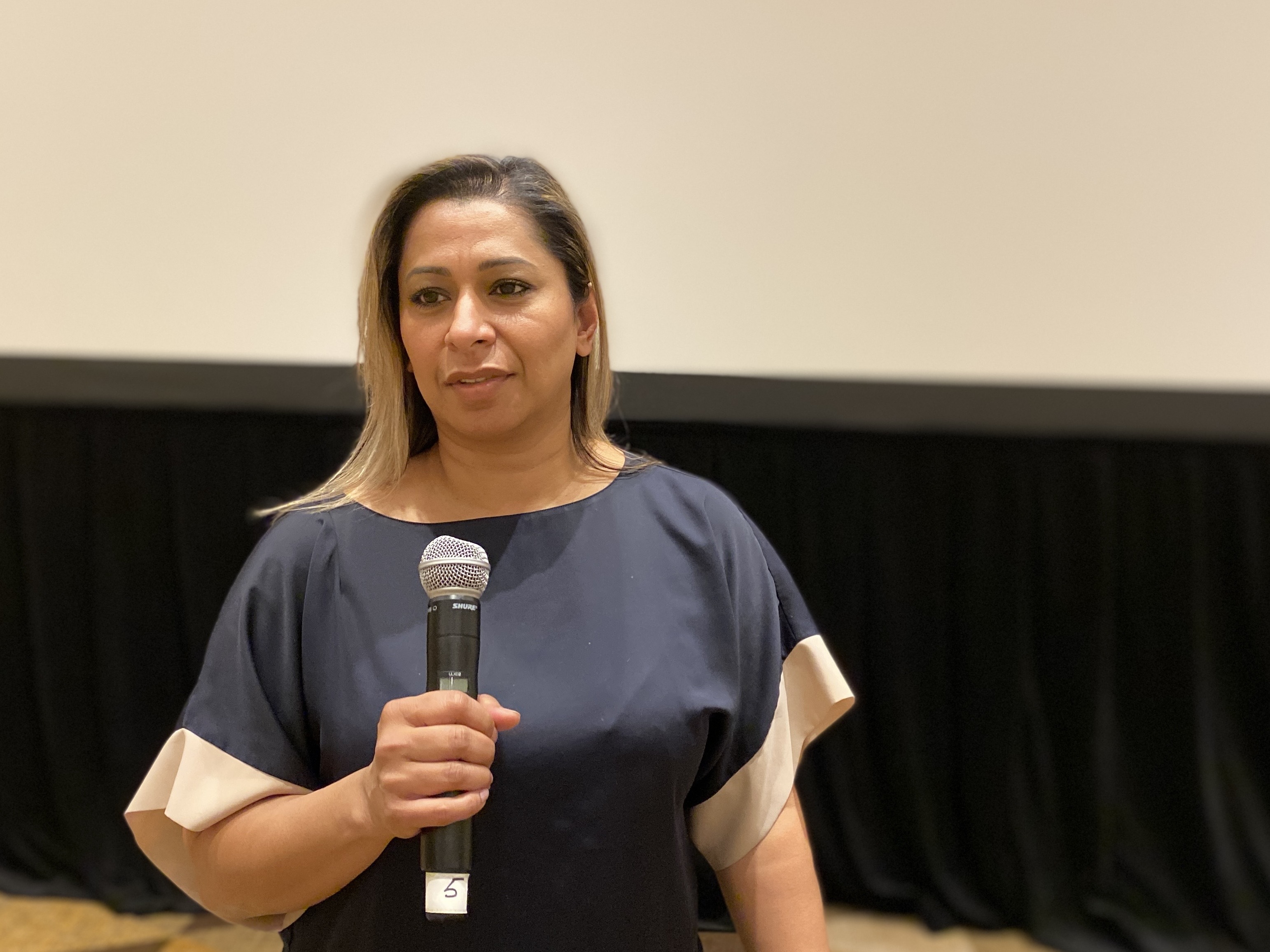 Unifor Ontario regional Director Naureen Rizvi speaks at a microphone