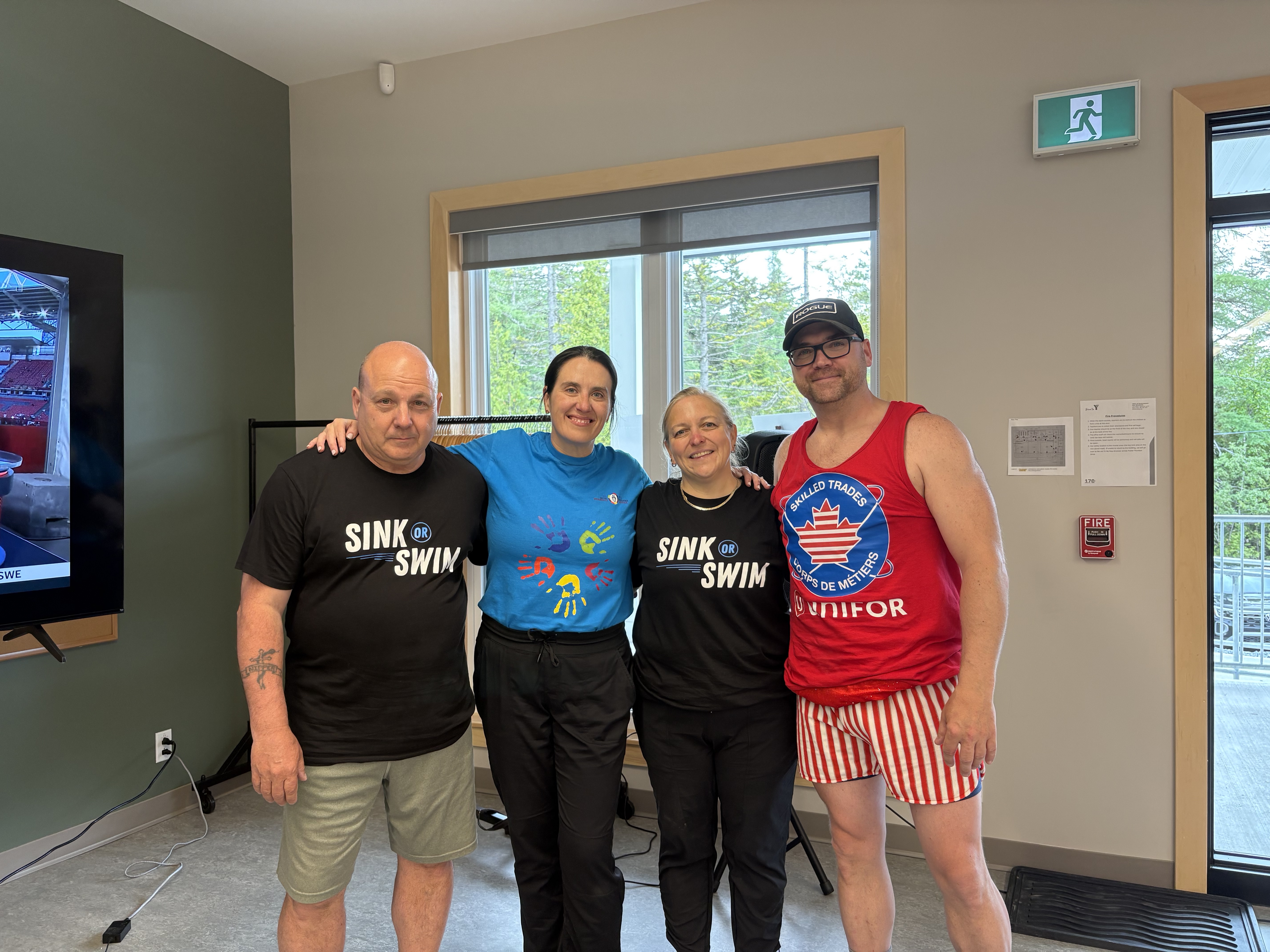 Four people posing smiling