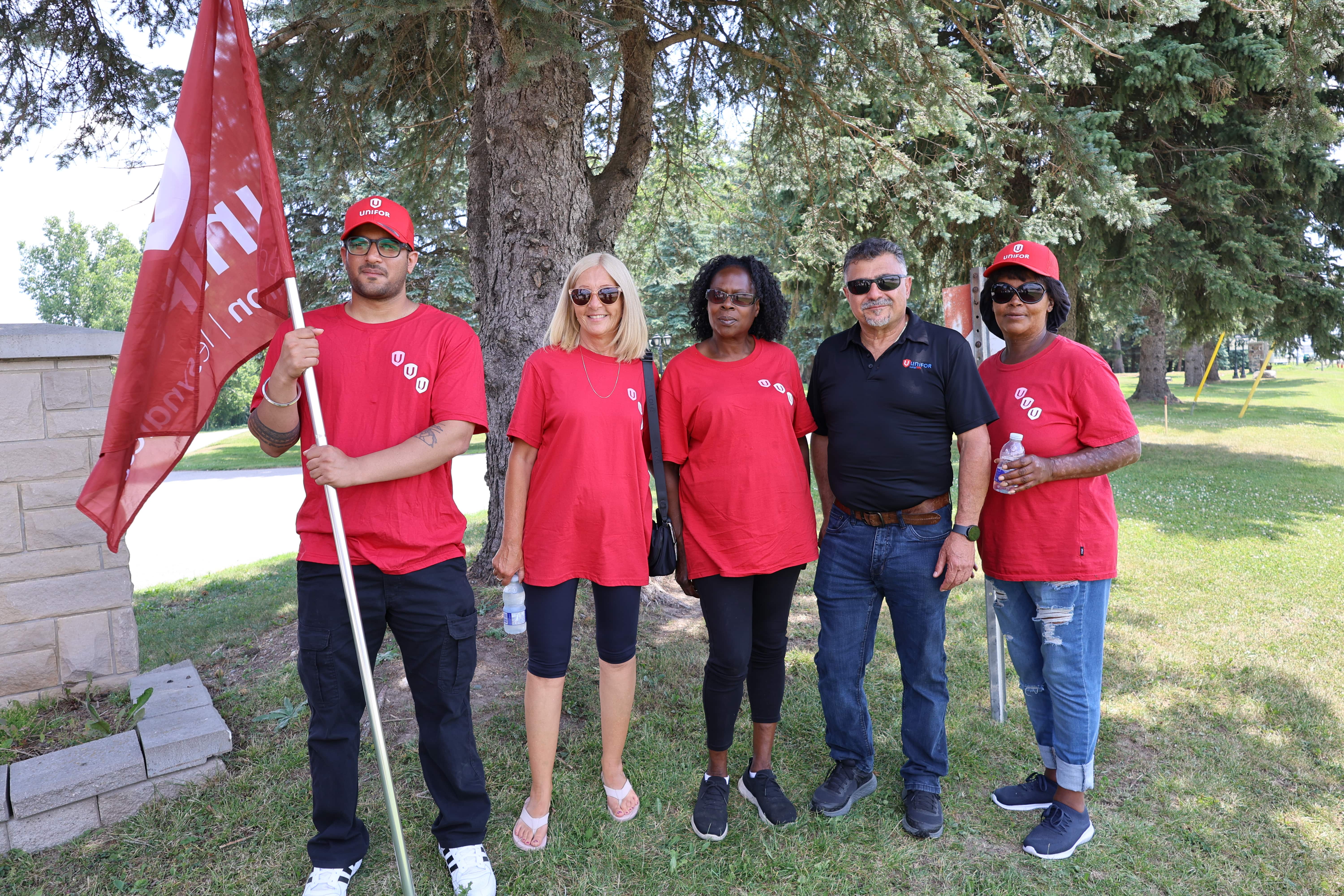six people standing by a tree