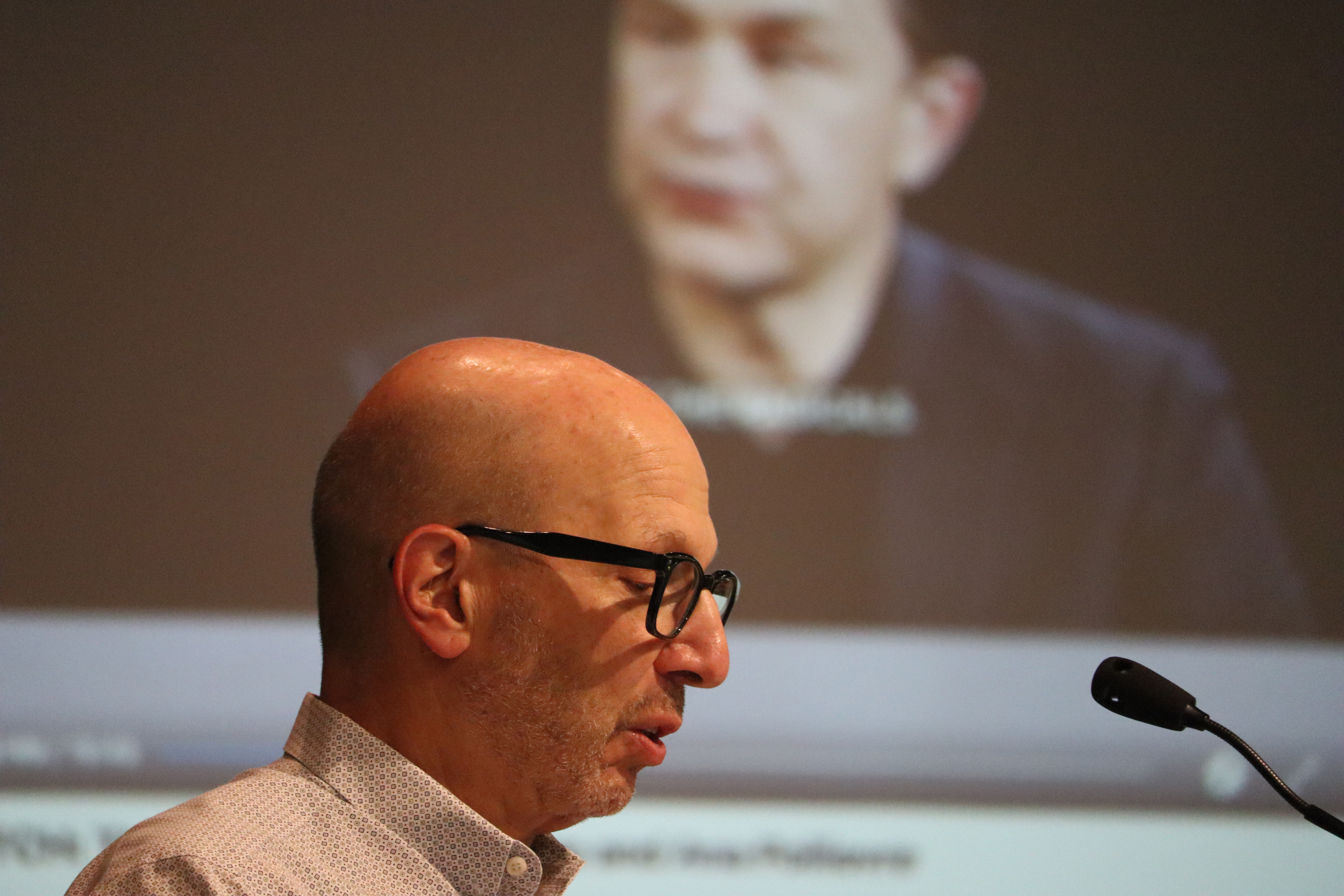 A man speaks at a podium