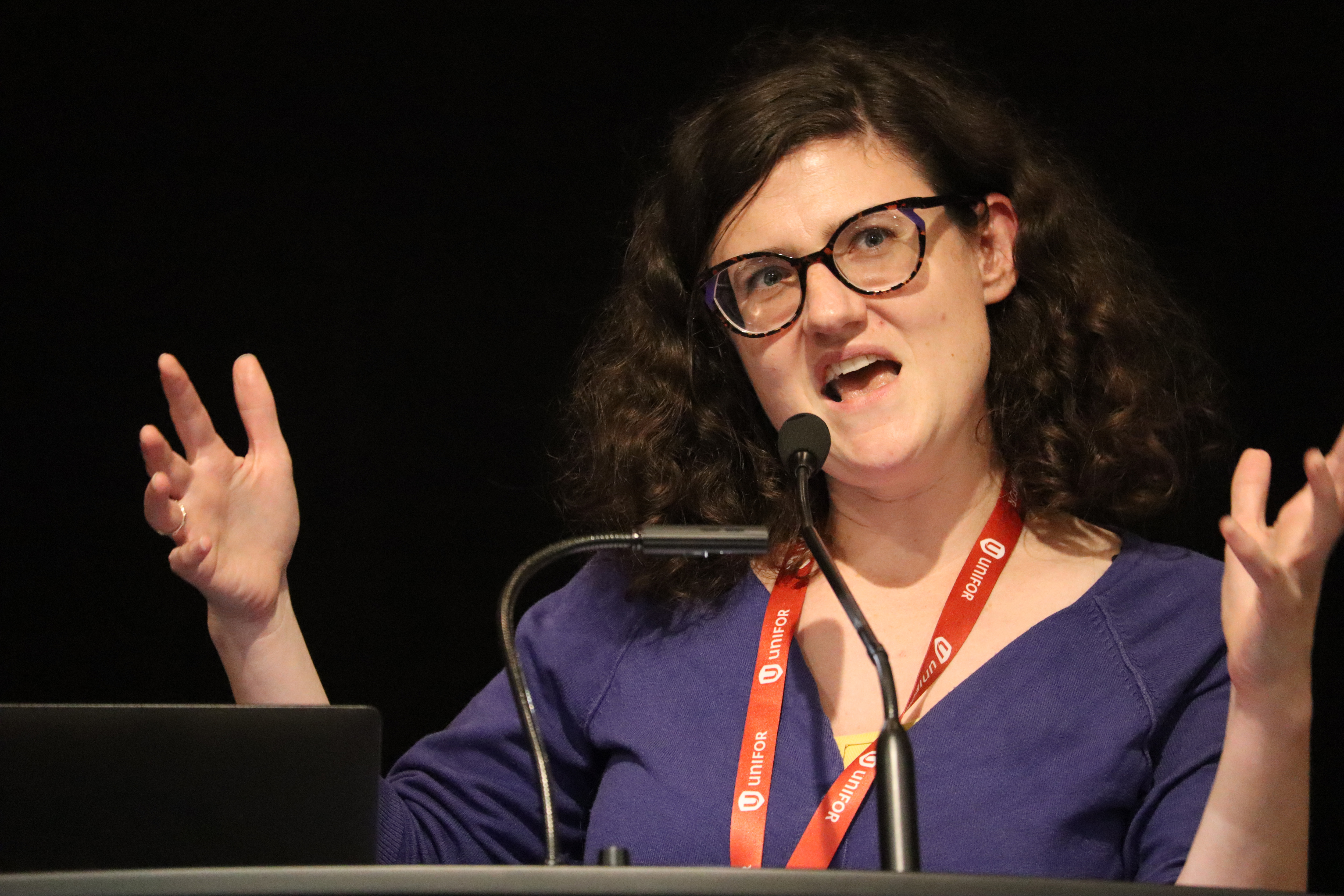 A women speaks at a mic