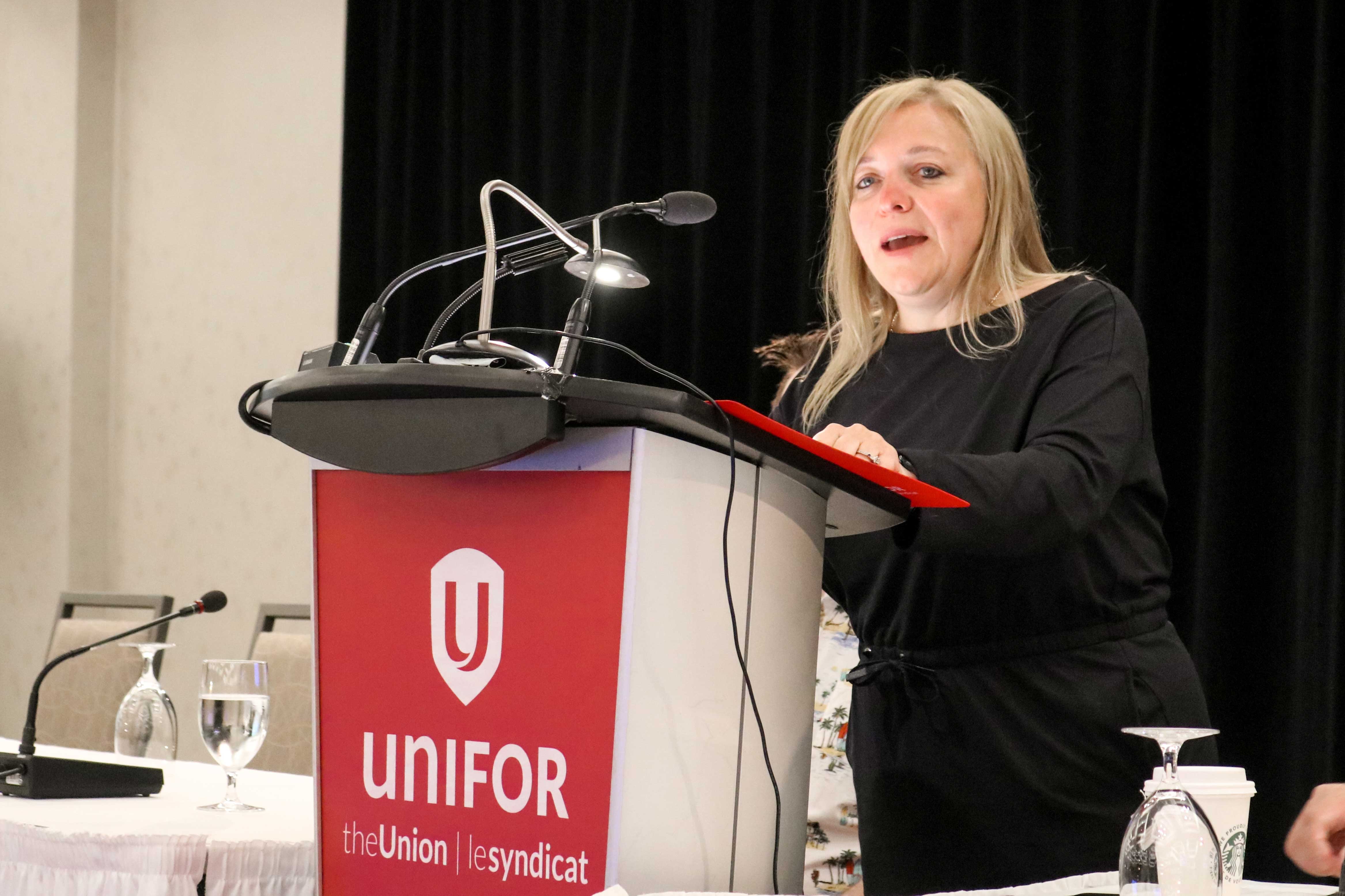 A woman speaking at podium