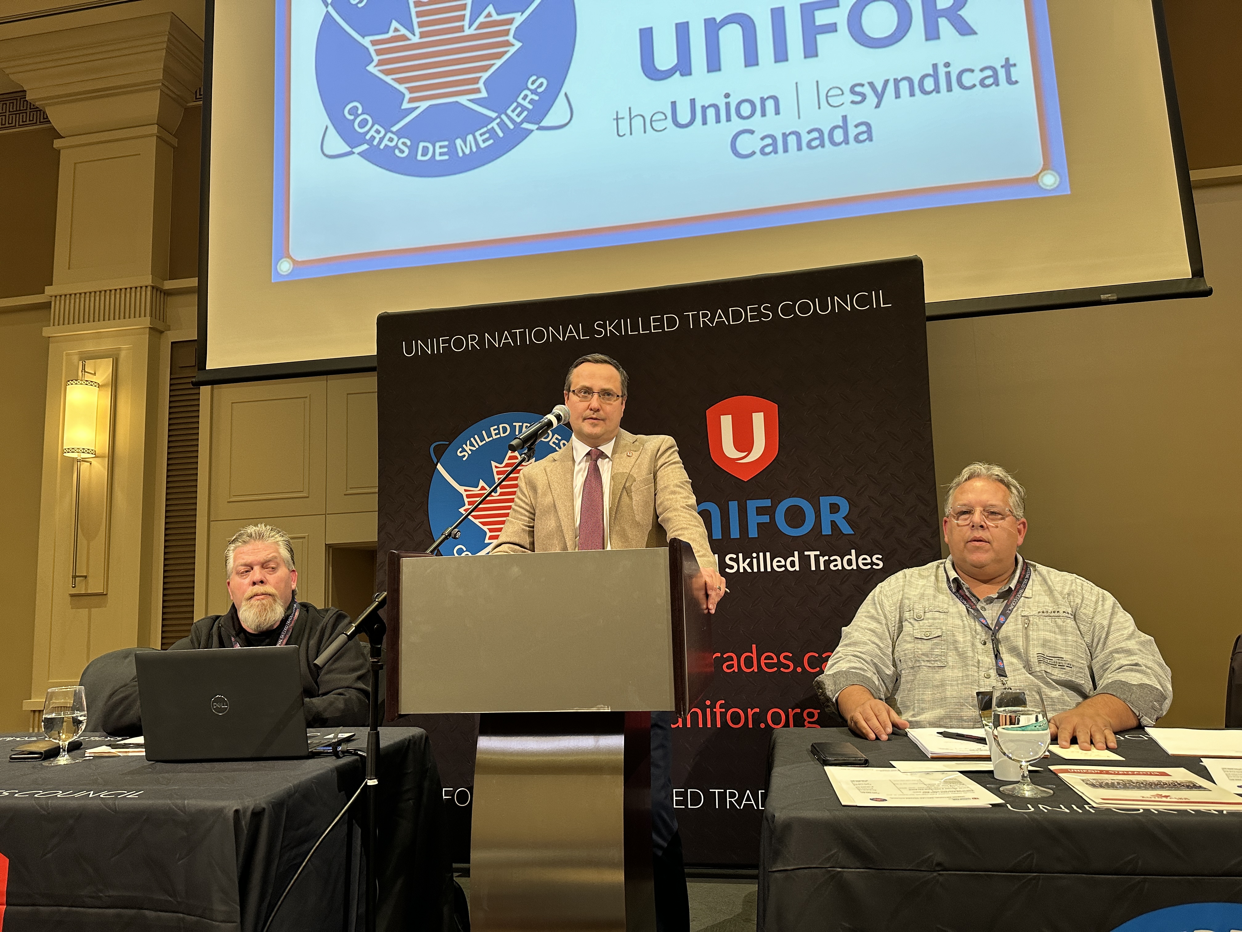 A man speaks at a podium