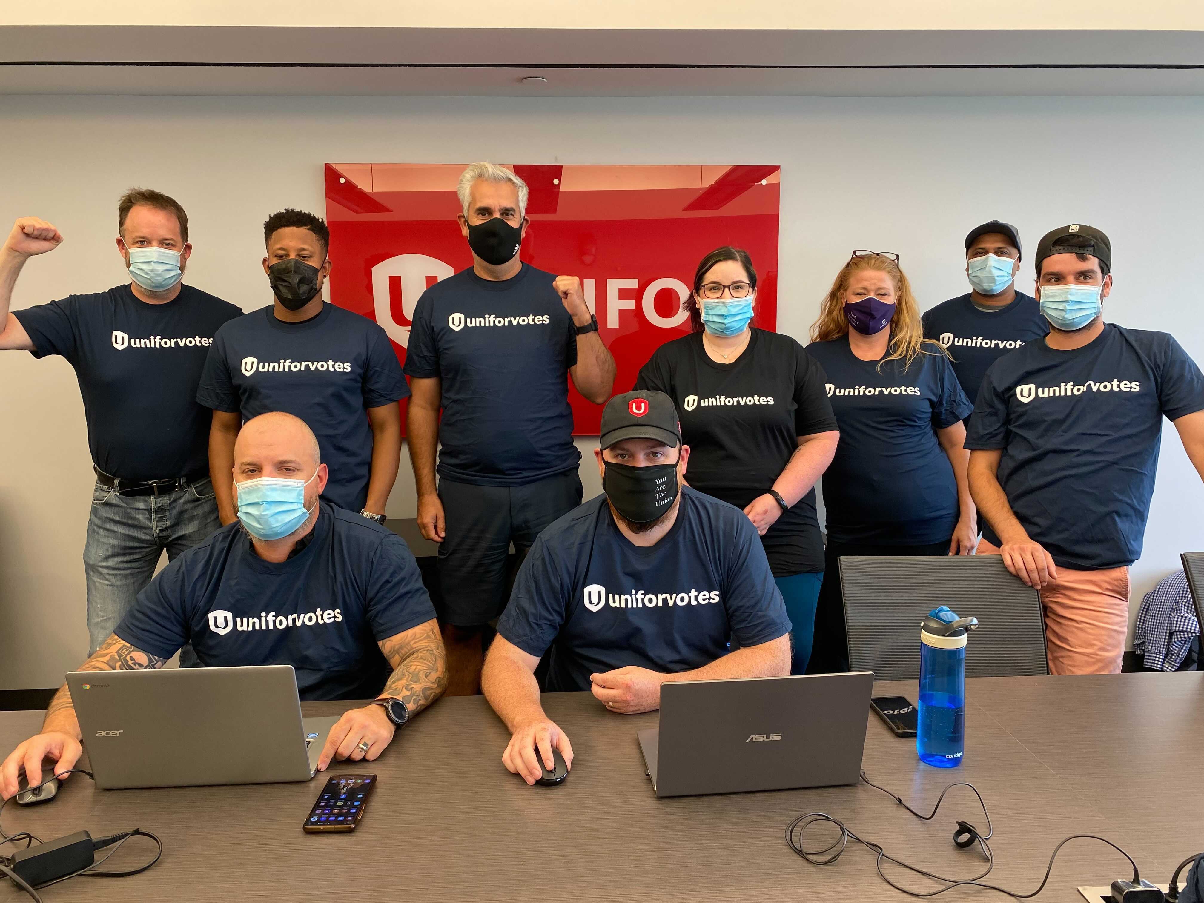 Unifor Votes member volunteers 2021 Unifor member volunteers wearing black Unifor Votes T-shirts raise fists on eve of election