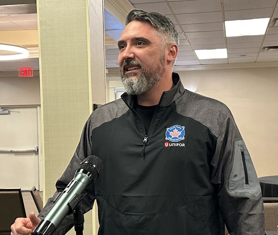 A man speaking at a mic