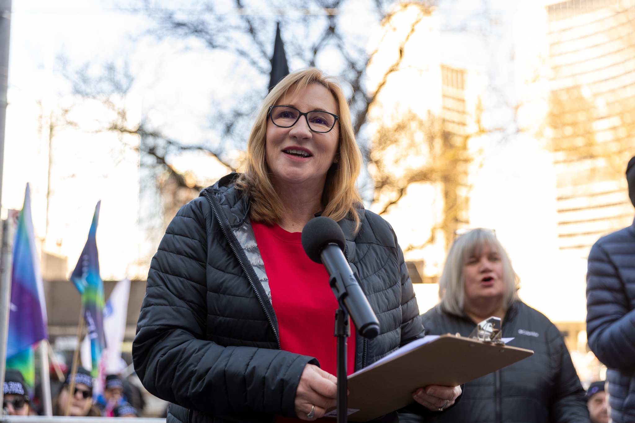 A women speaking outside at a mic