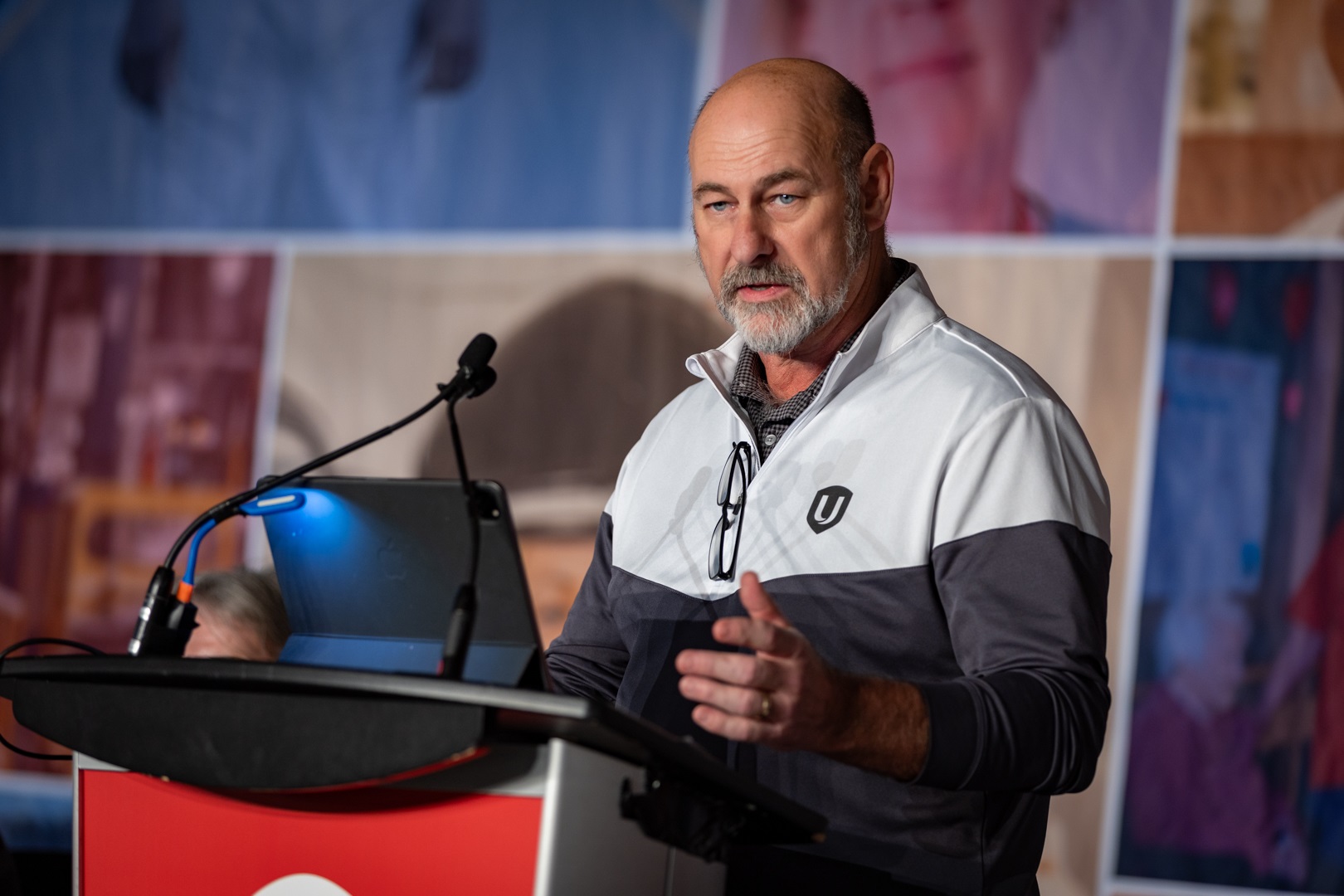 Len Poirier speaking at the podium