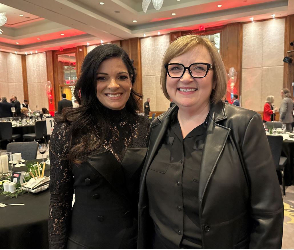 Two women dressed well smiling