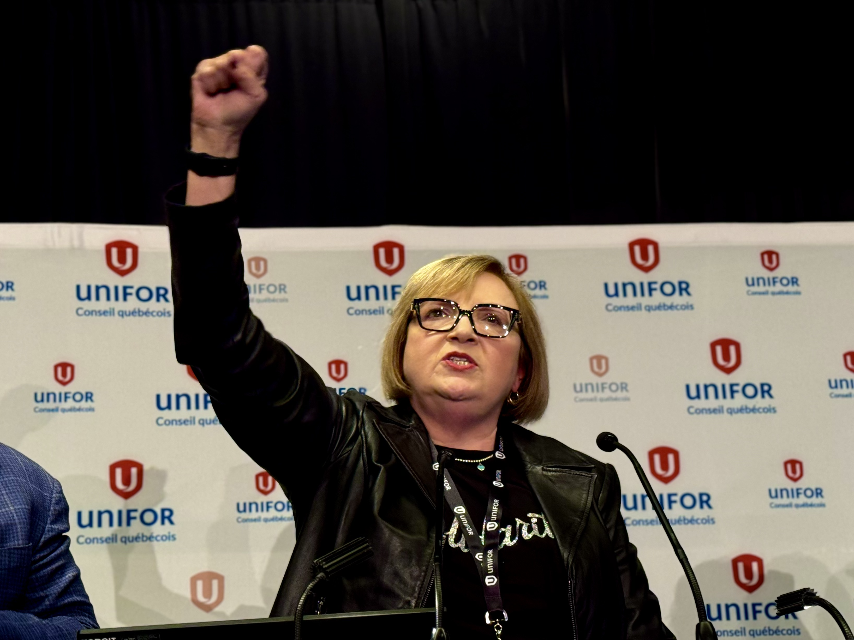 A woman standing with her fist in the air