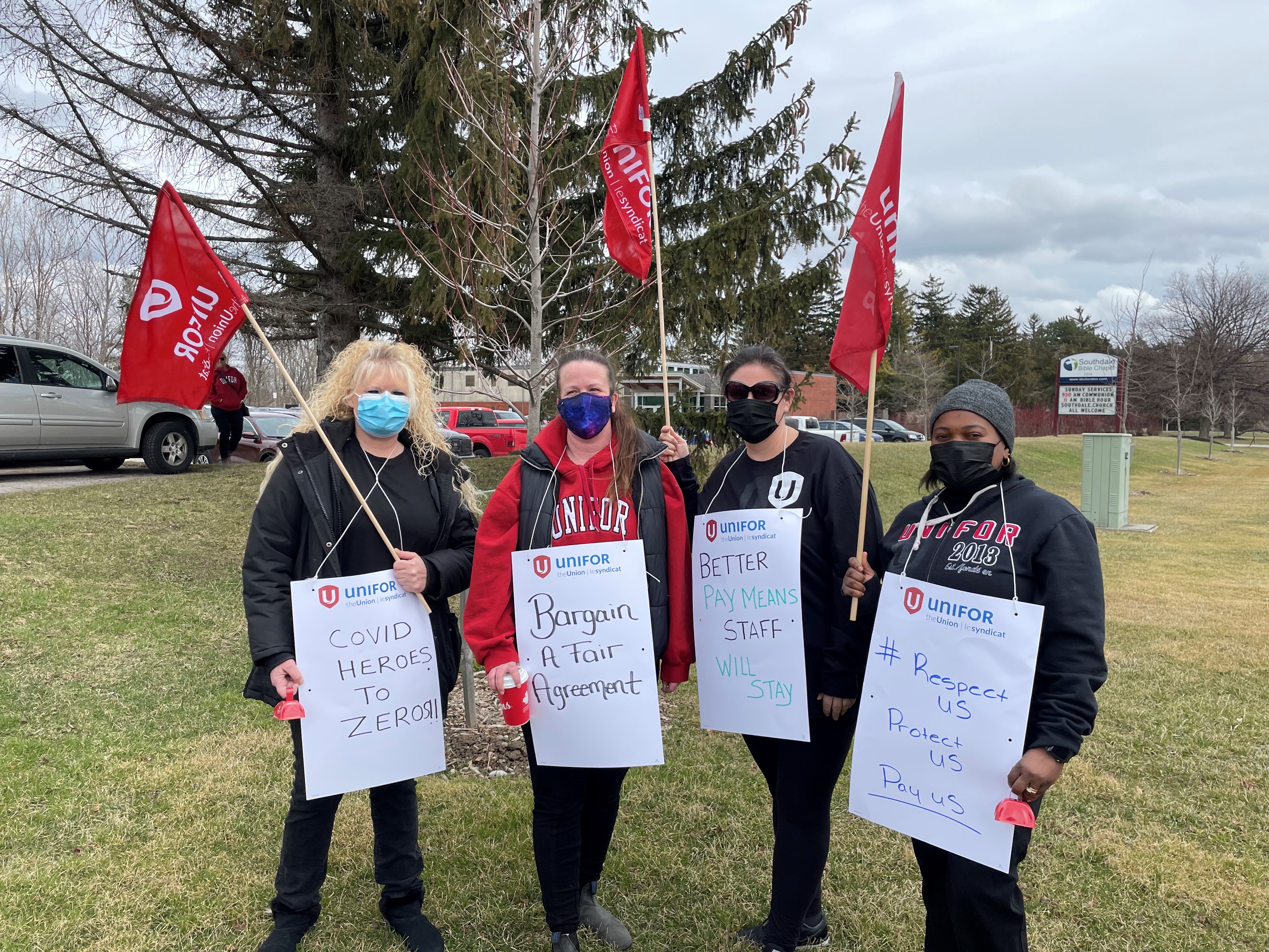 Unifor health care workers hold signs at a London LTC rally. 