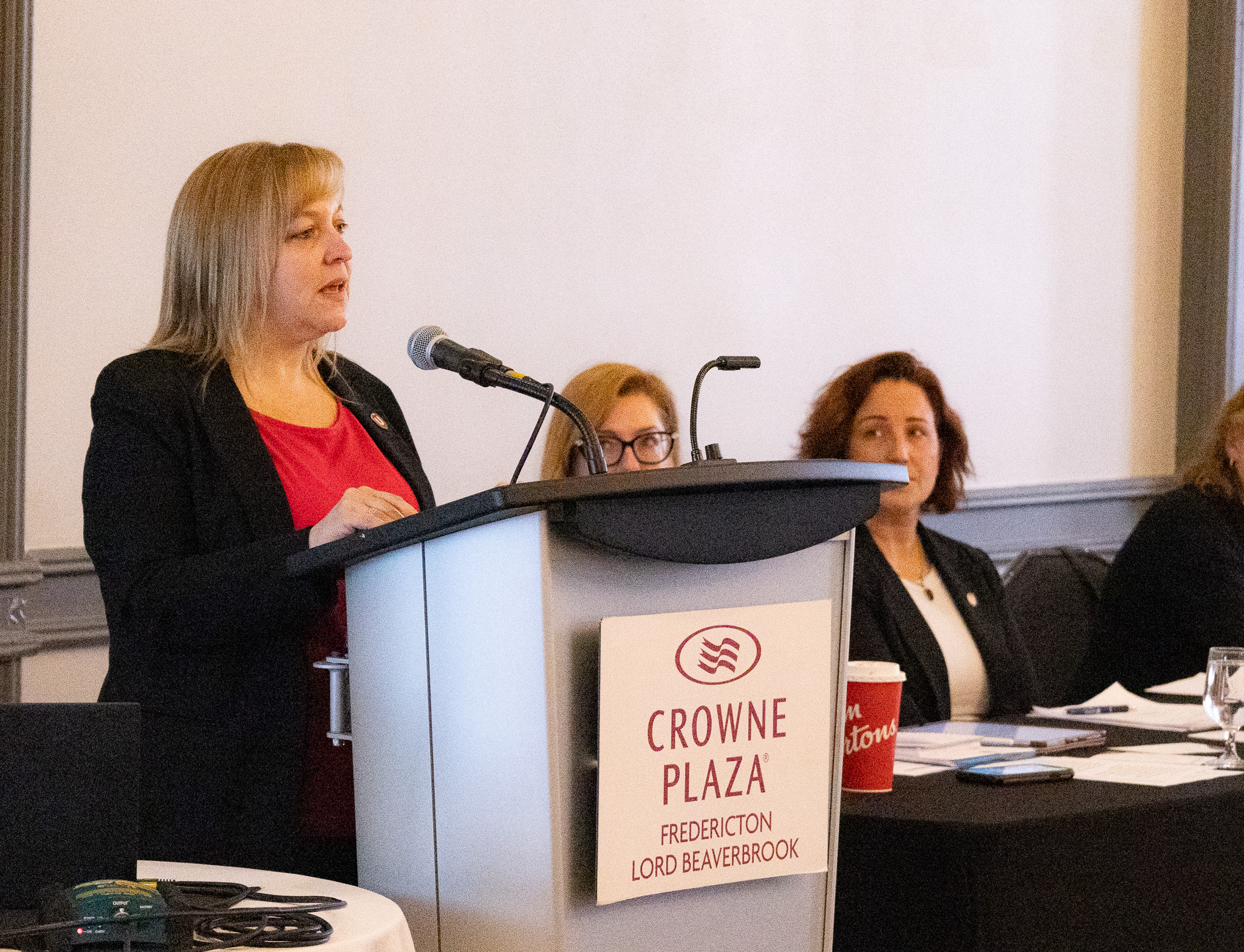 A women speaks at a podium