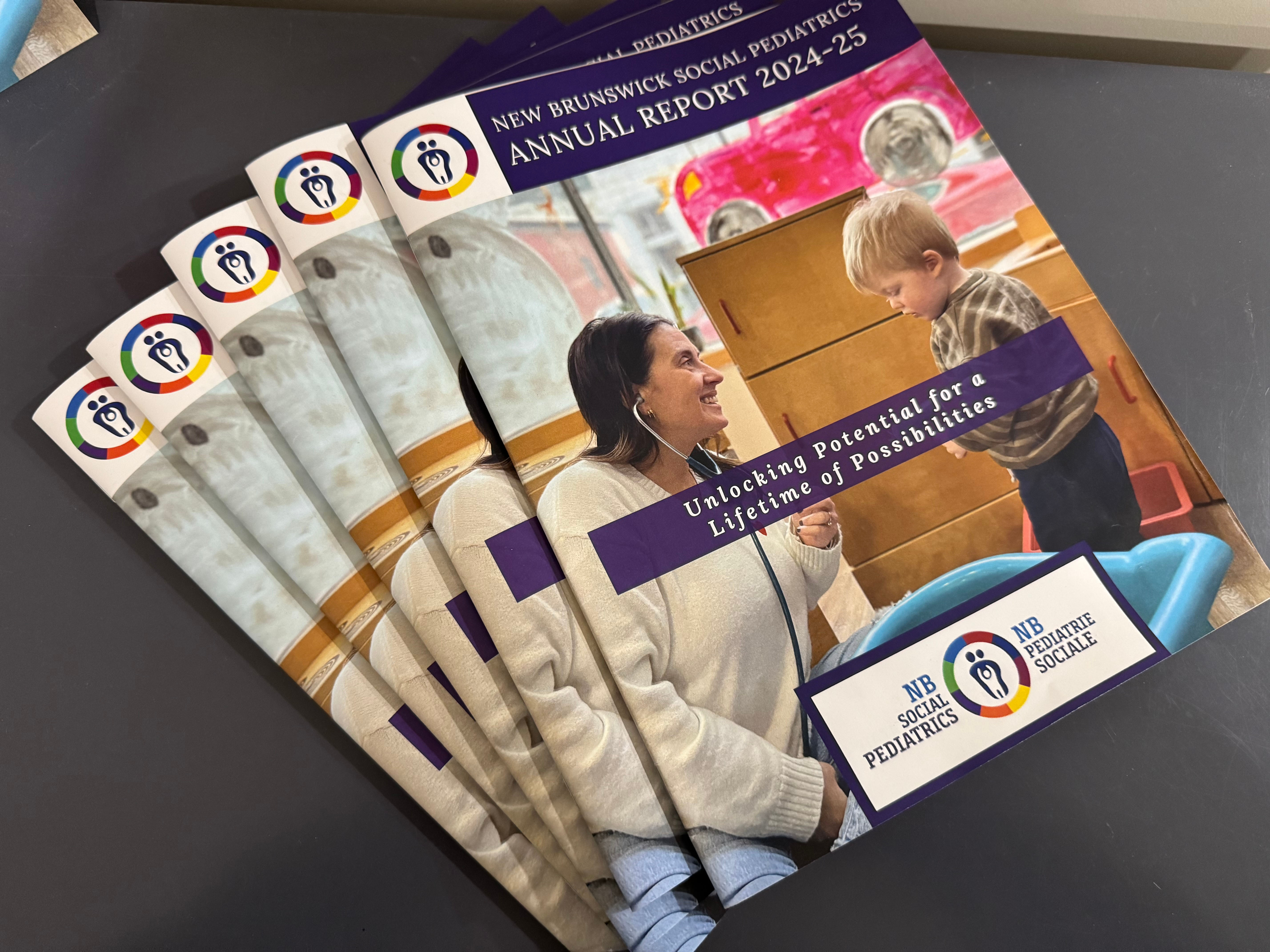 Five New Brunswick Social Pediatrics annual reports fanned out on a table