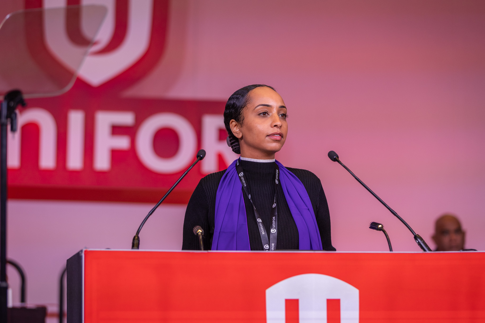 A women speaking at a podium.