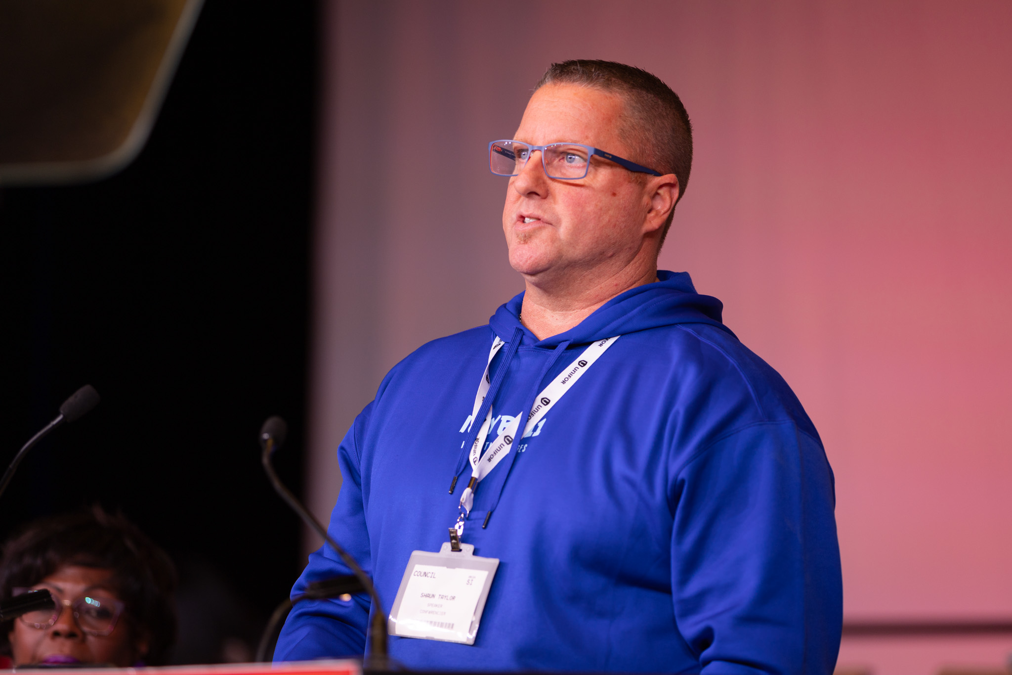 A man speaking at a mic.