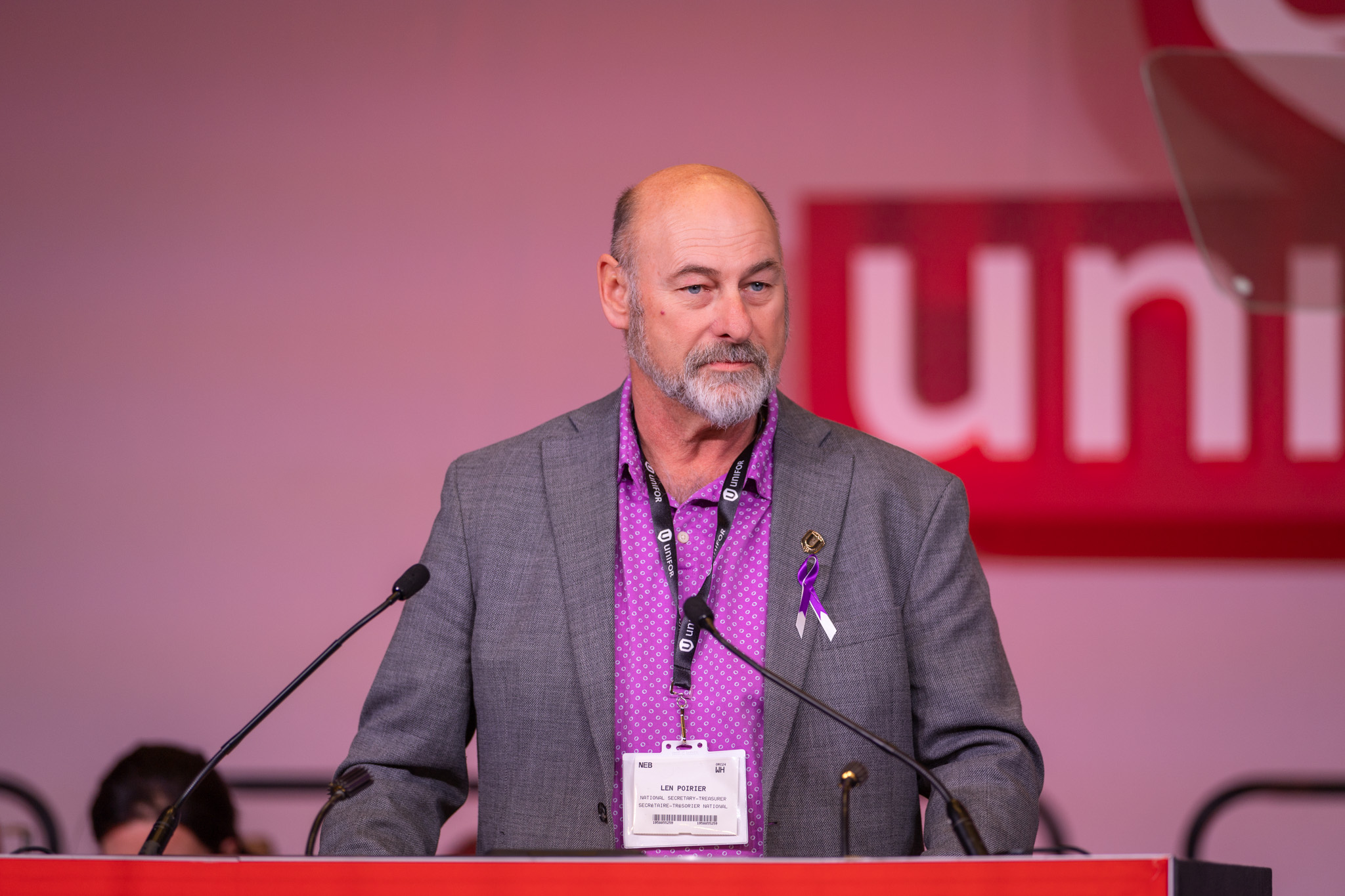 A man speaks at a mic.