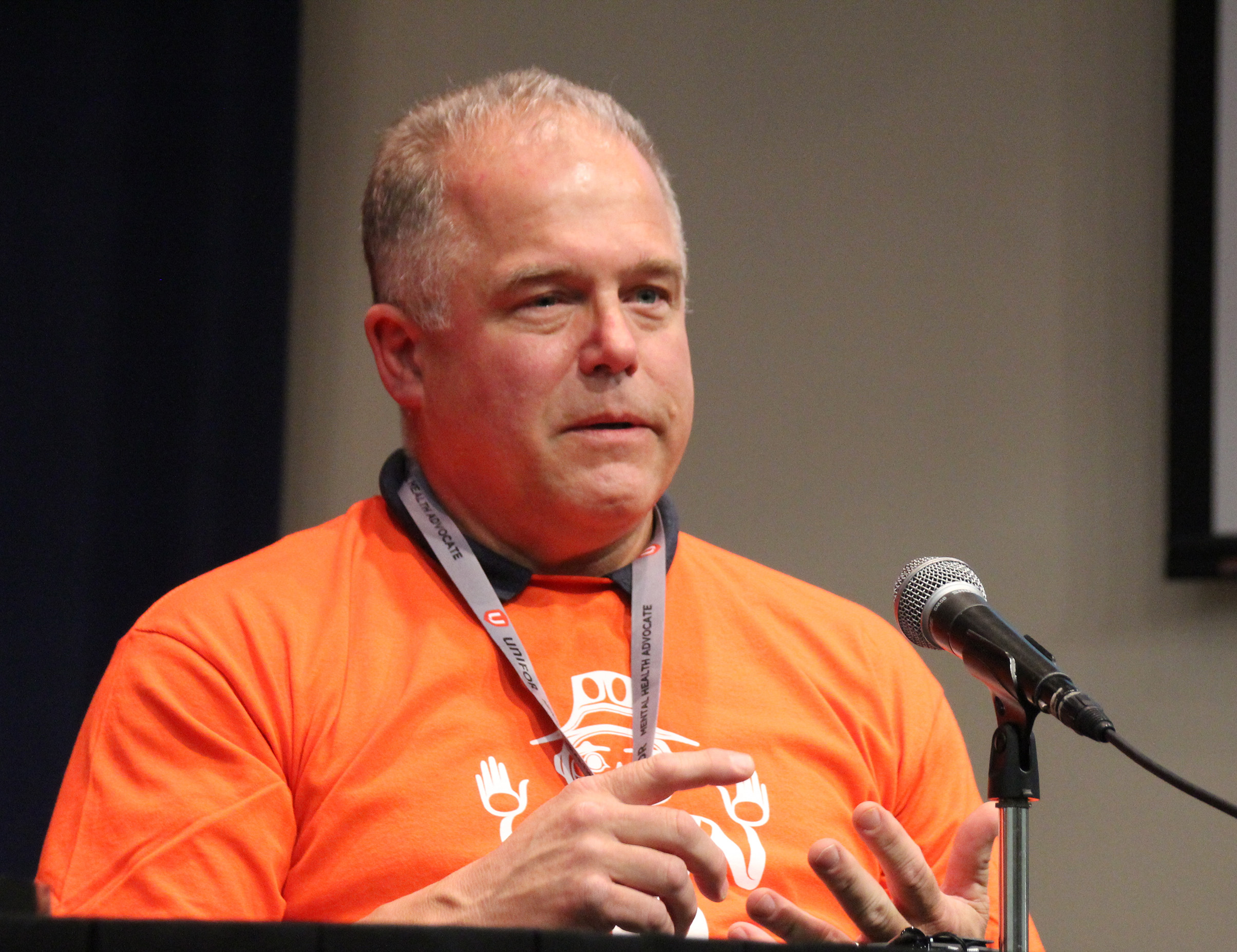 Peter Zanon speaking at a microphone