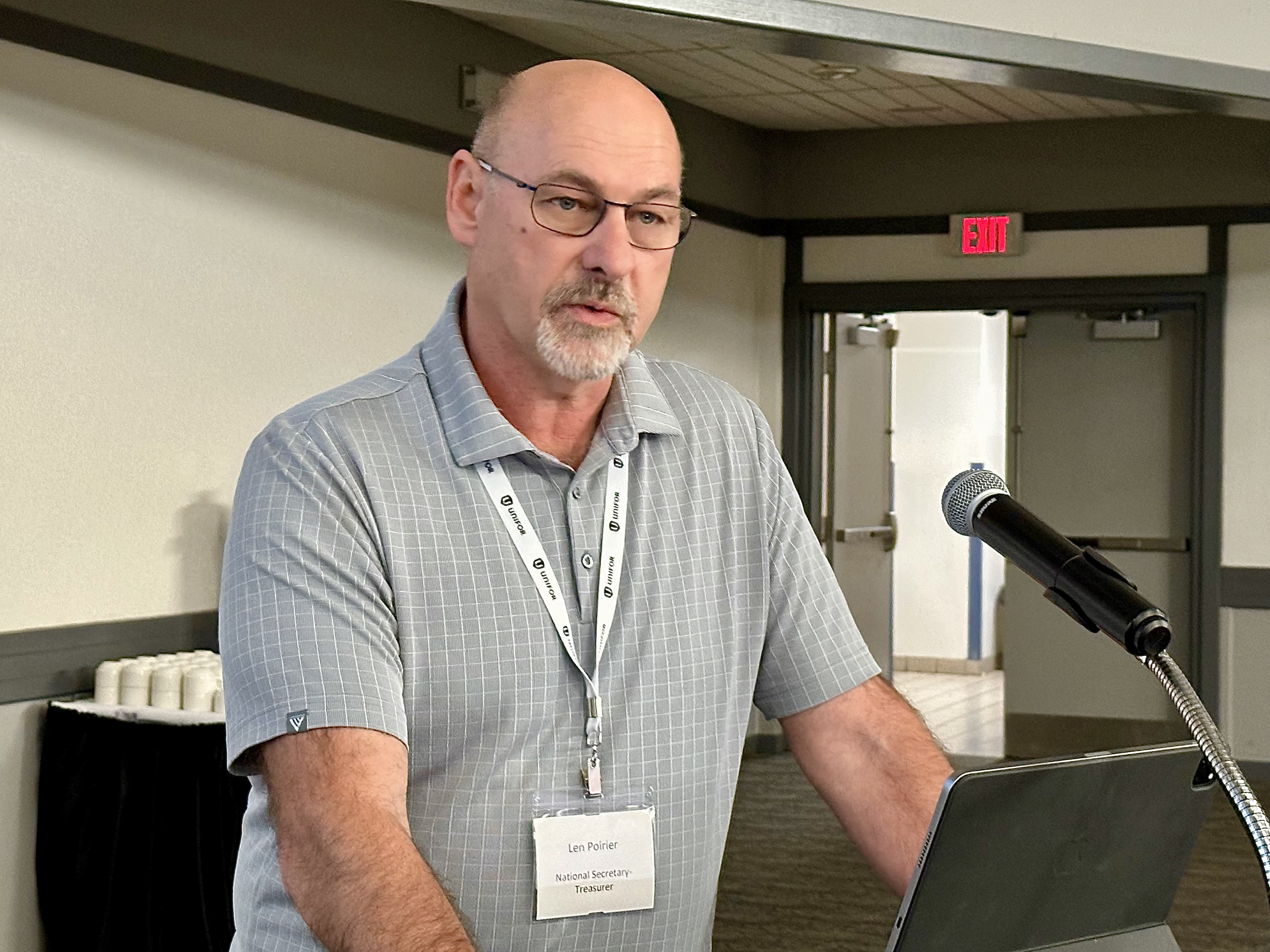 A man speaking at the mic.