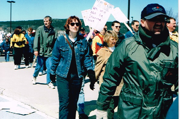 Protest march with some people holding placards.