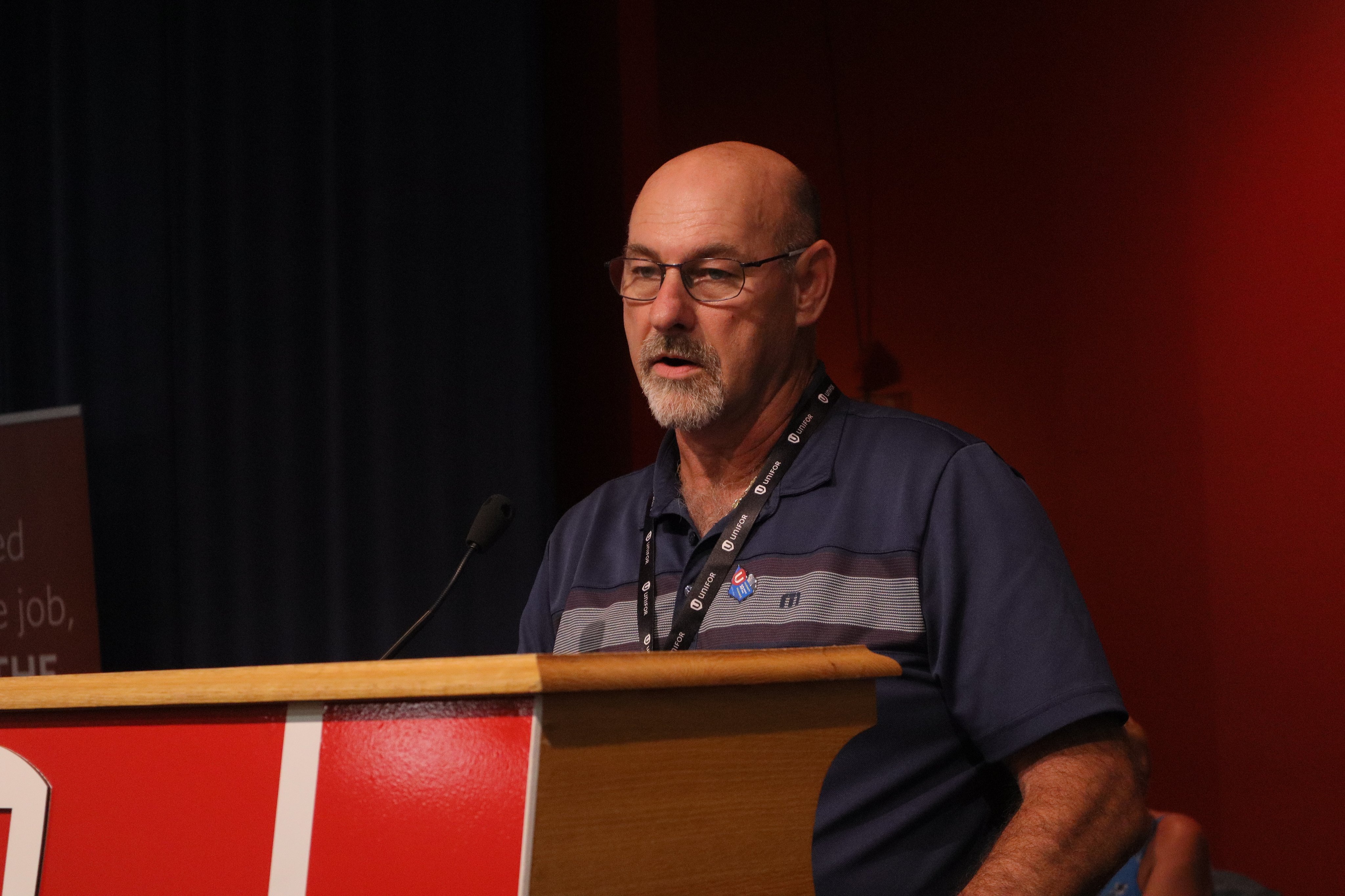 A man speaking at a podium