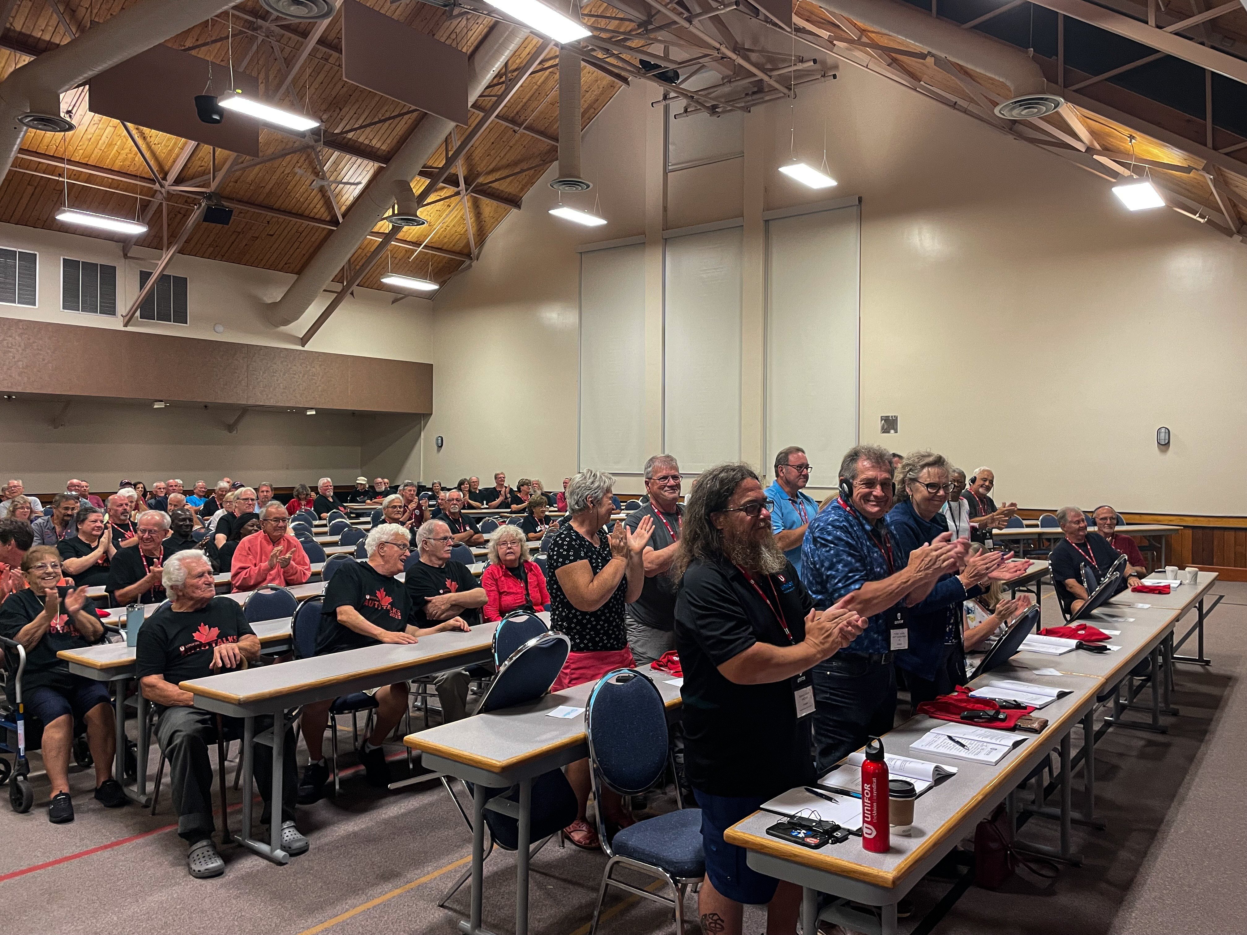 People giving a standing ovation at a conference.