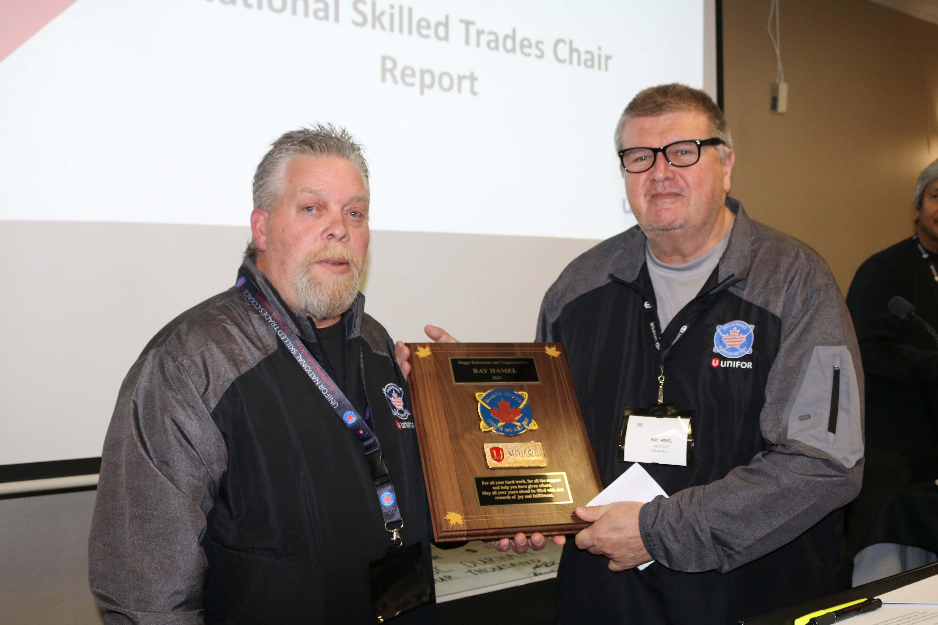 Two men holding up an award