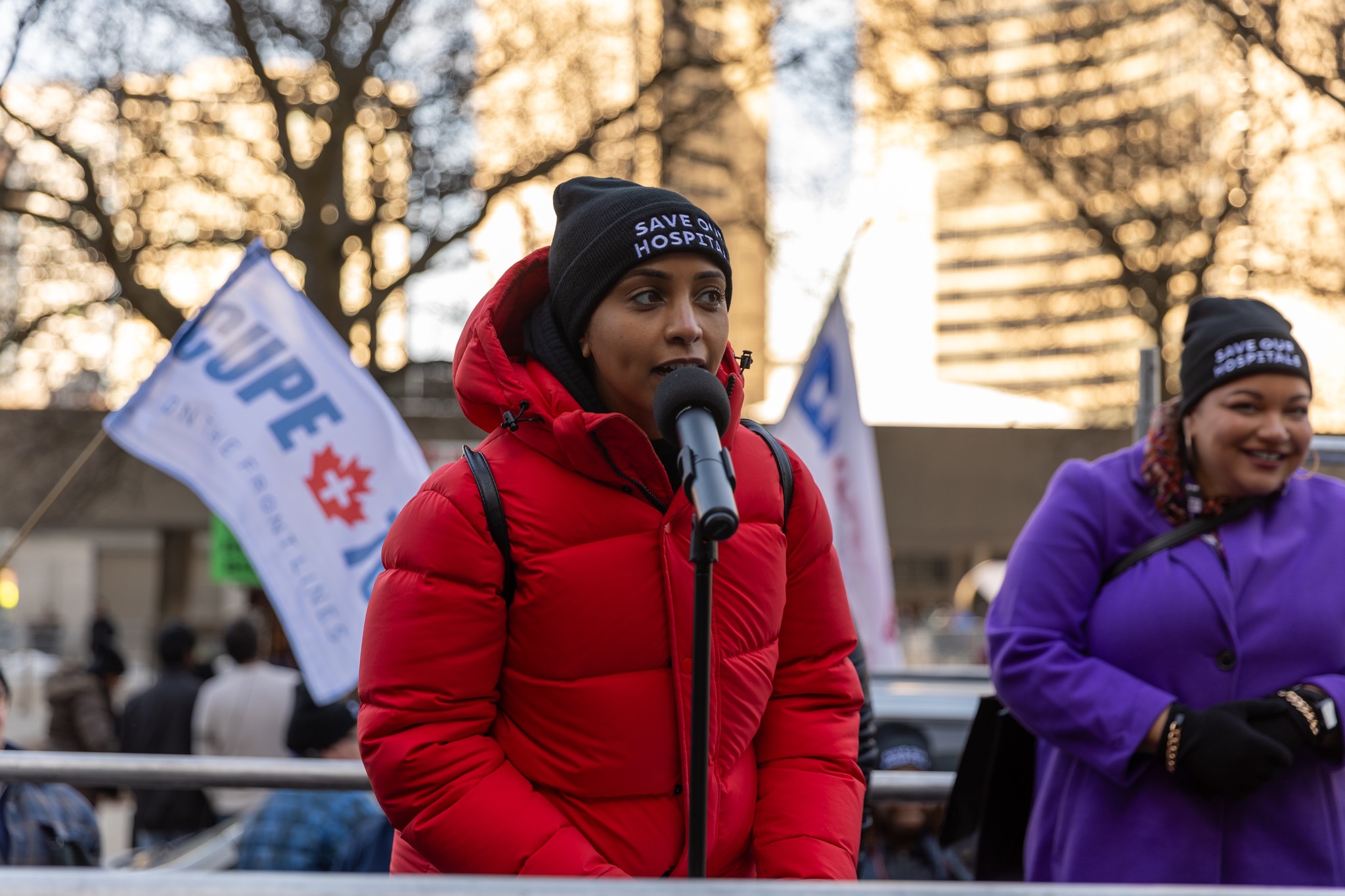 A women speaking outside at a mic