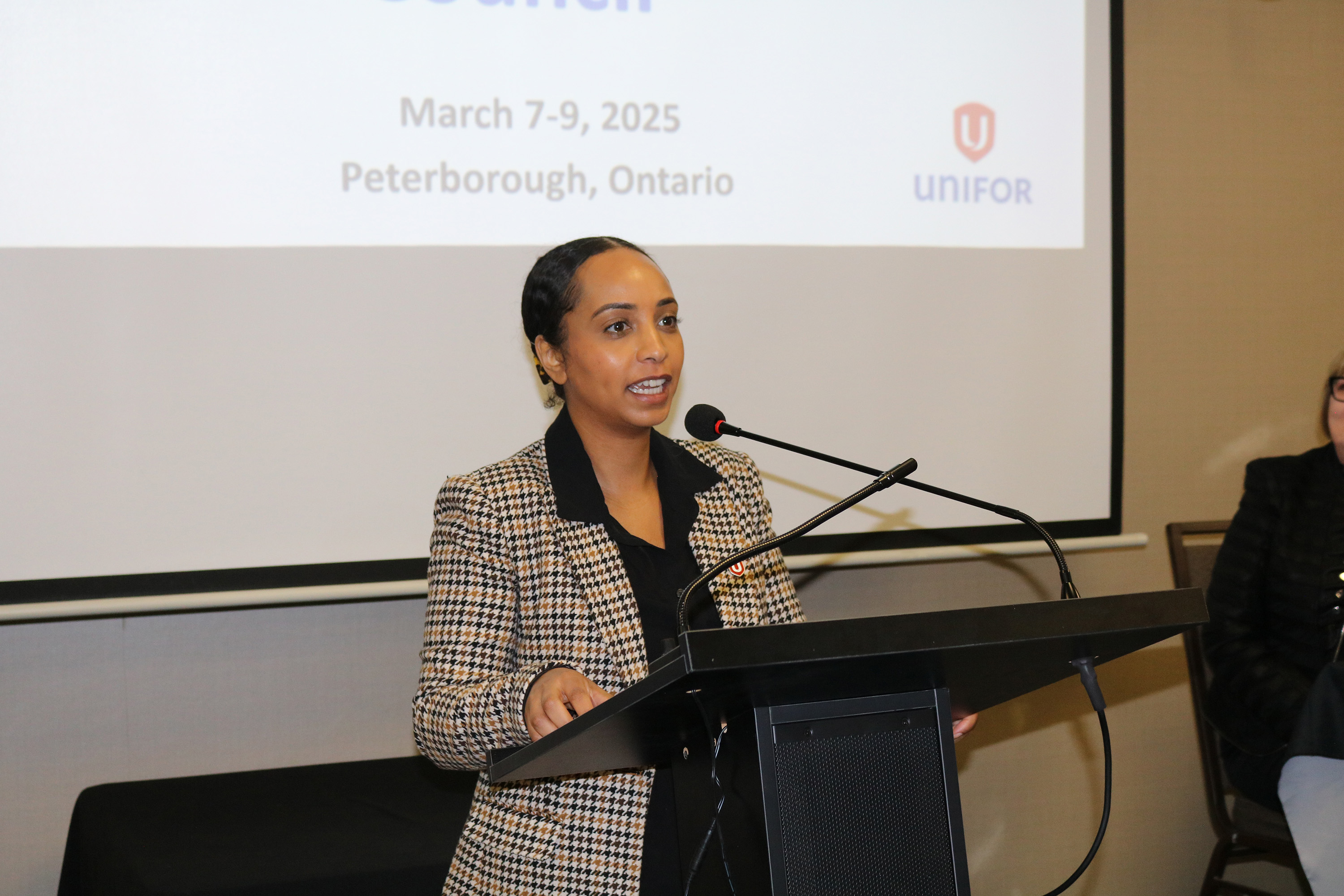 A women speaks at a podium.